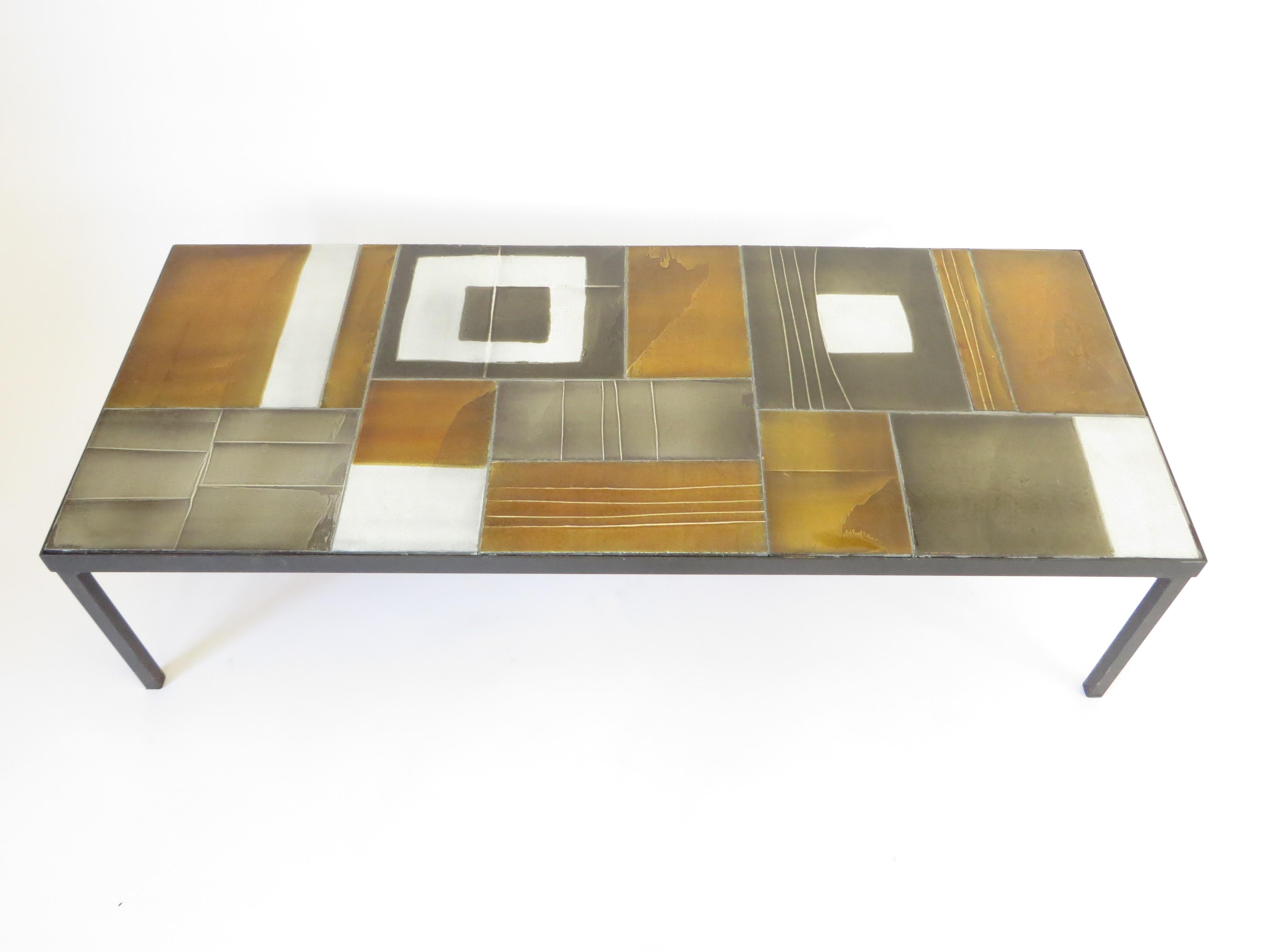Roger Capron French ceramic artist from Vallauris signed multi color coffee table of glazed lave tiles set in a black iron frame.
Colors of amber, ochre, gray, and white compose the tiles of this table and signed in the corner.
Measures: 47.5