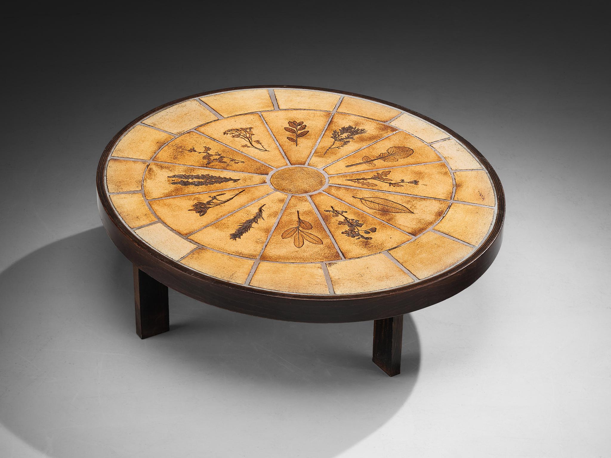 Roger Capron, coffee table, ceramic, beech, France, 1960s

This table is another exquisite example of Roger Capron’s work, showcasing an oval tabletop composed of his preferred material, ceramic, with intricate organic detailing that lends a