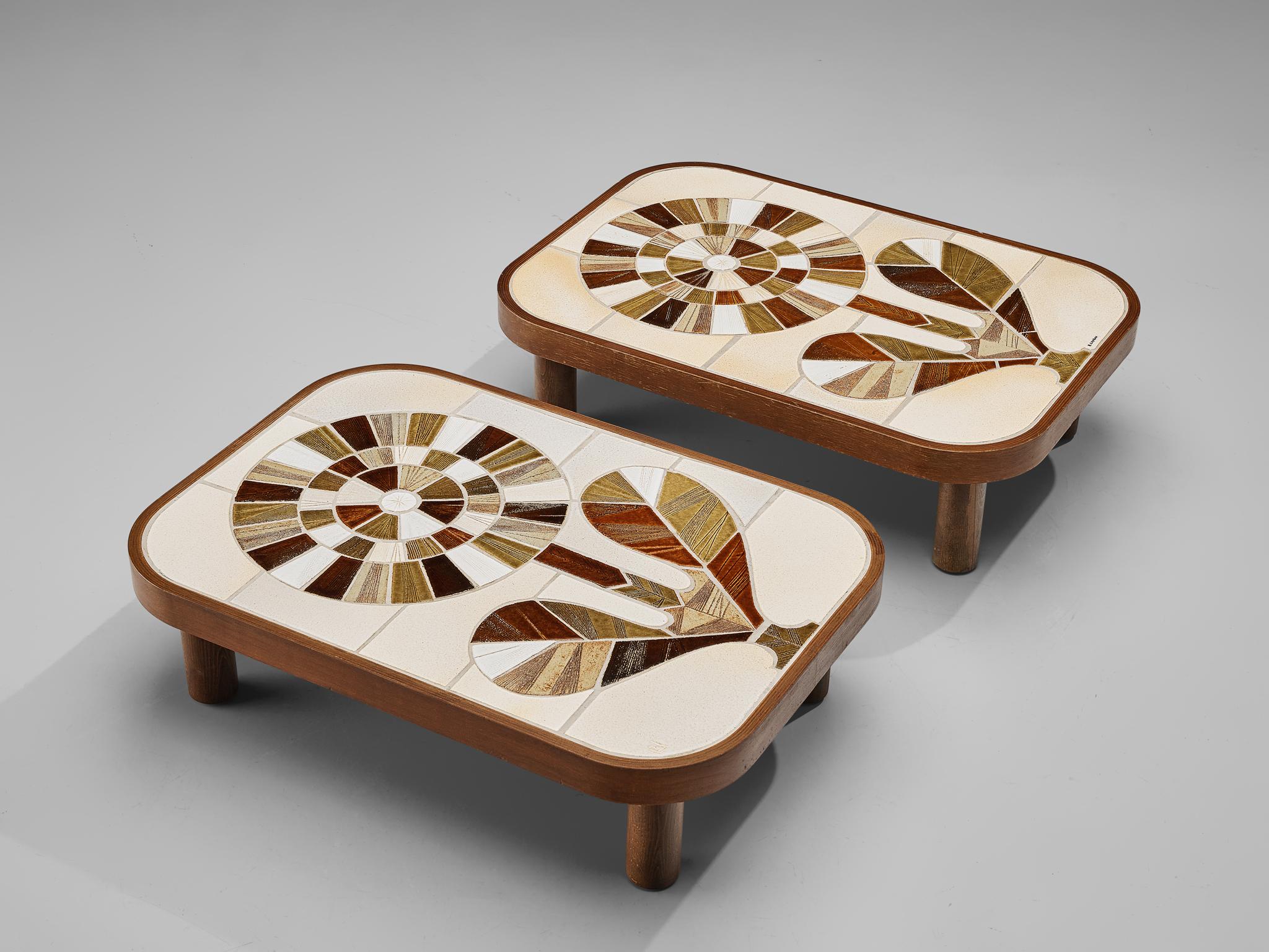 Roger Capron, coffee tables, ceramic, wood, France, 1960s 

French coffee tables with wonderful composed ceramic tiles by French ceramic artist Roger Capron. Both tables feature a vibrant motif of a flower created by differently colored fragments. A