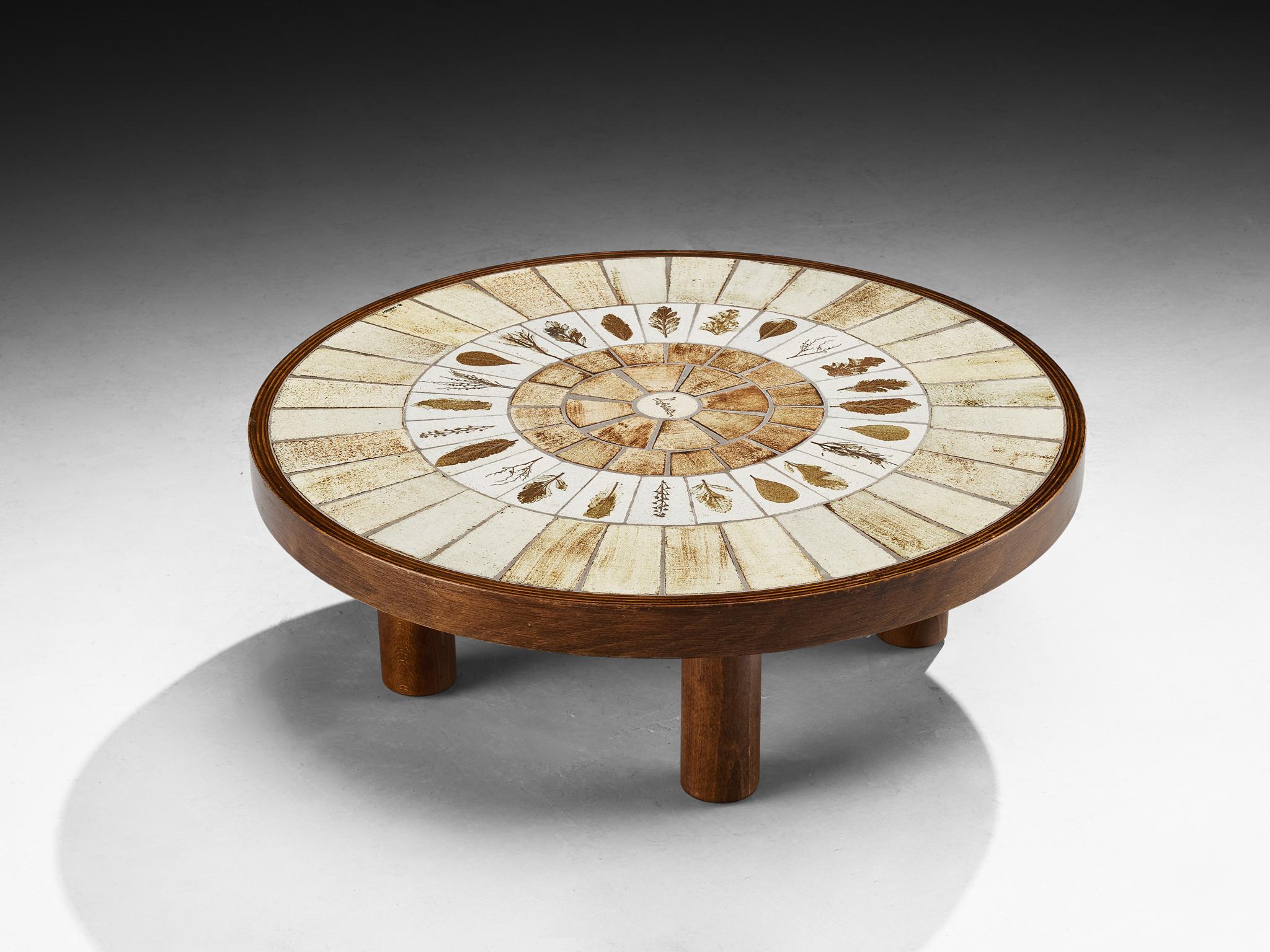 Roger Capron, coffee table, ceramic, beech, France, 1960s

This table is another exquisite example of Roger Capron’s work, showcasing a round tabletop composed of his preferred material, ceramic, with intricate organic detailing that lends a