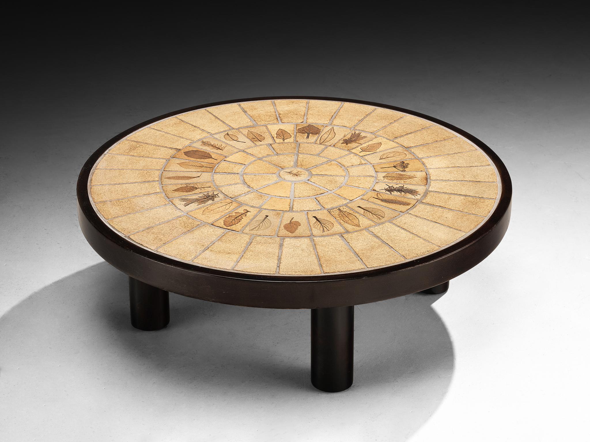 Roger Capron, coffee table, ceramic, beech, France, 1960s

This table is another exquisite example of Roger Capron’s work, showcasing a round tabletop composed of his preferred material, ceramic, with intricate organic detailing that lends a
