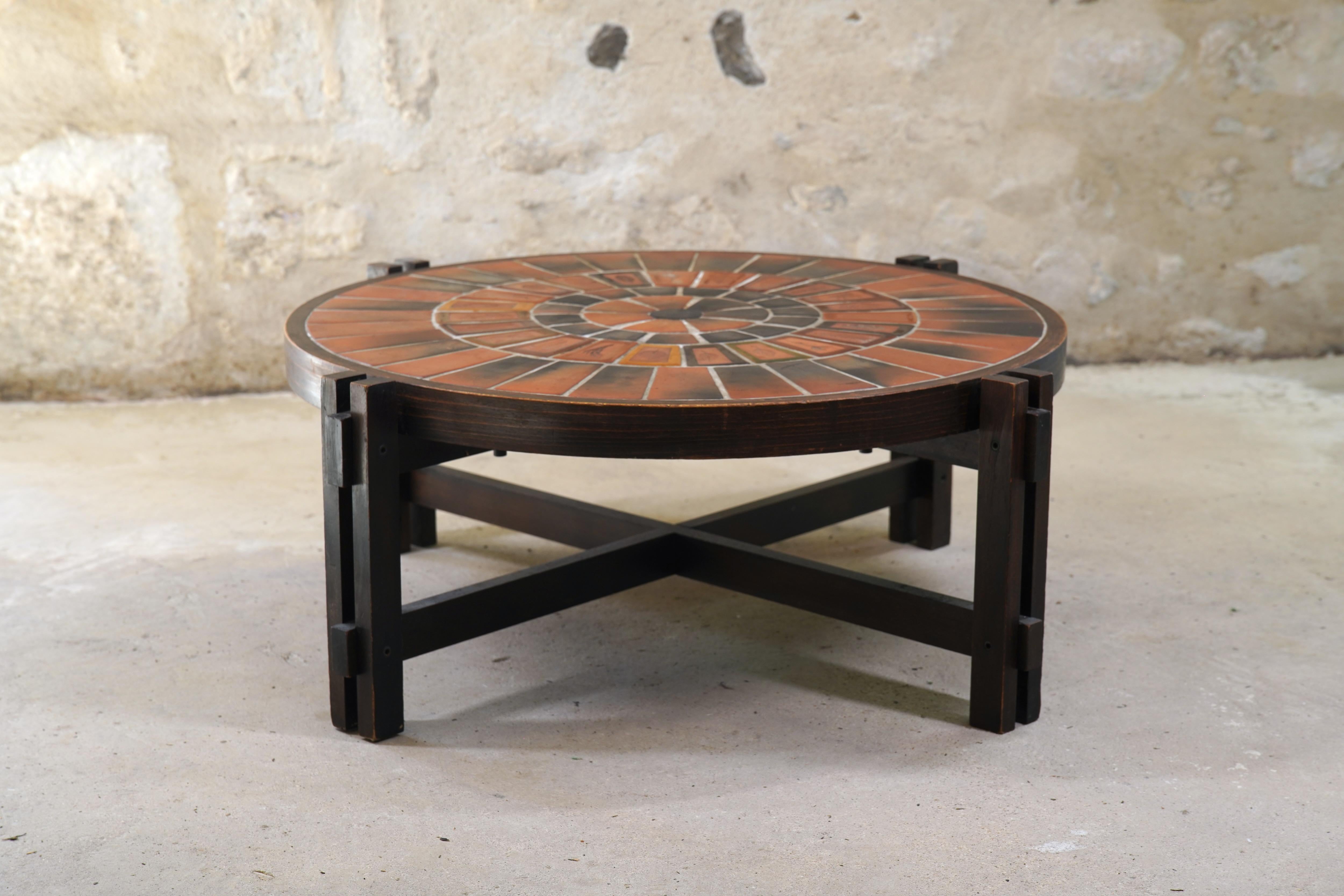Wonderful Roger Capron ceramic coffee table with Garrigue tiles from France, circa 1960s.

The handcrafted Garrigue tiles were produced by a technique in which real leaves were pressed into the clay and, during firing, disintegrated, leaving a