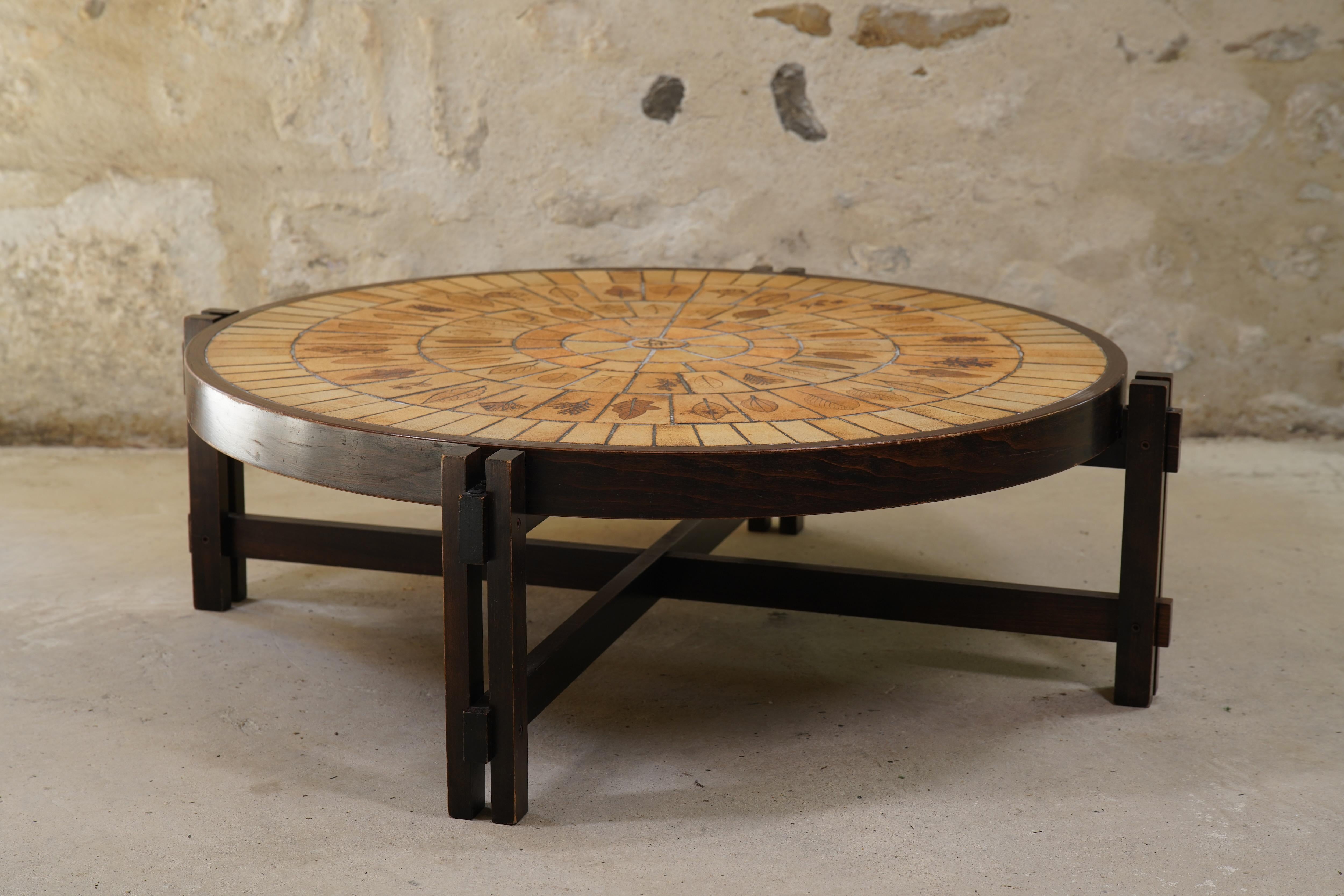 Ravissante table basse en céramique Roger Capron avec des carreaux de Garrigue de France, vers les années 1960.

Les carreaux de Garrigue, fabriqués à la main, sont issus d'une technique où de vraies feuilles sont pressées dans l'argile et se