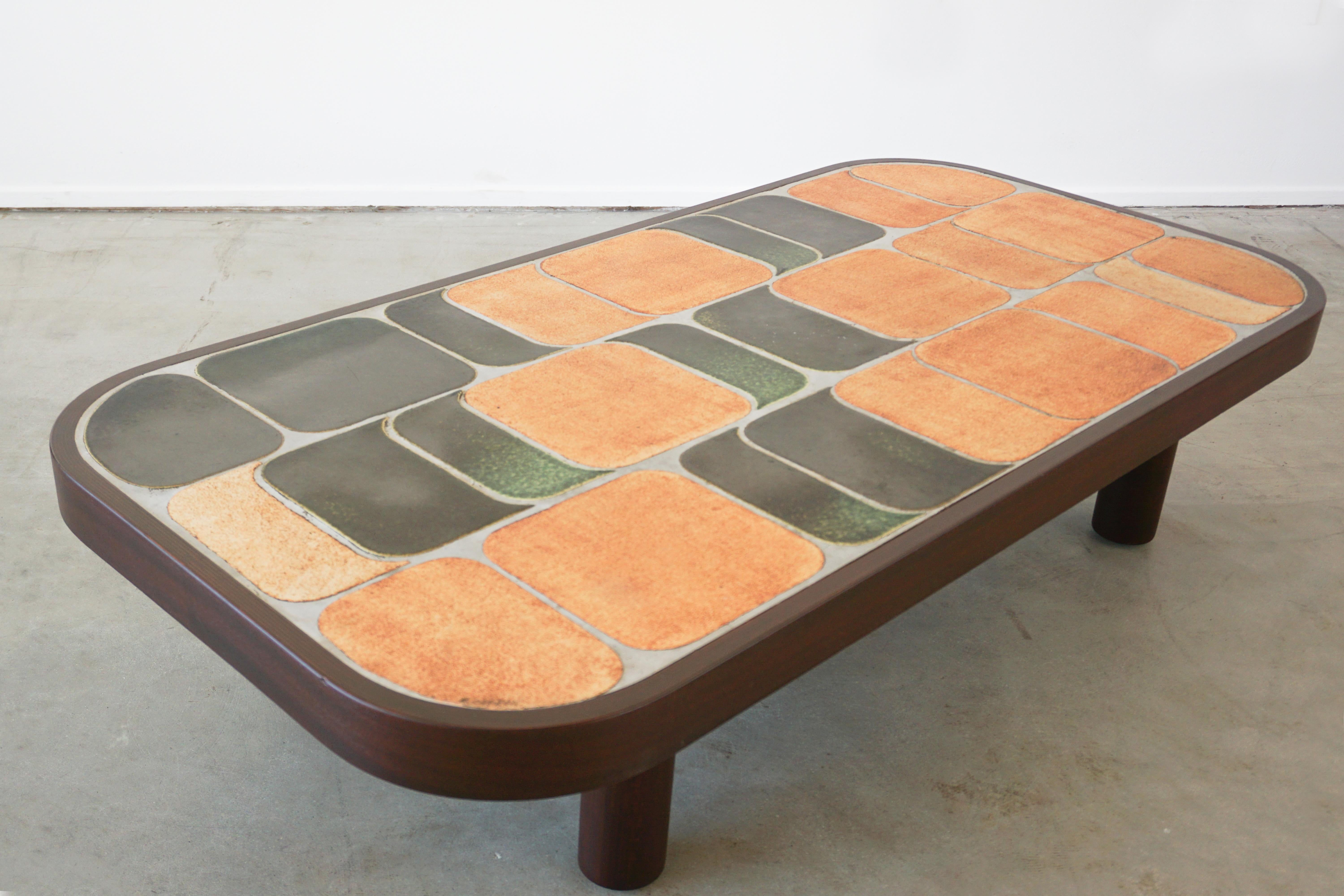 Large sized ceramic tile top coffee table designed by Roger Capron (signed).
Features his unique 