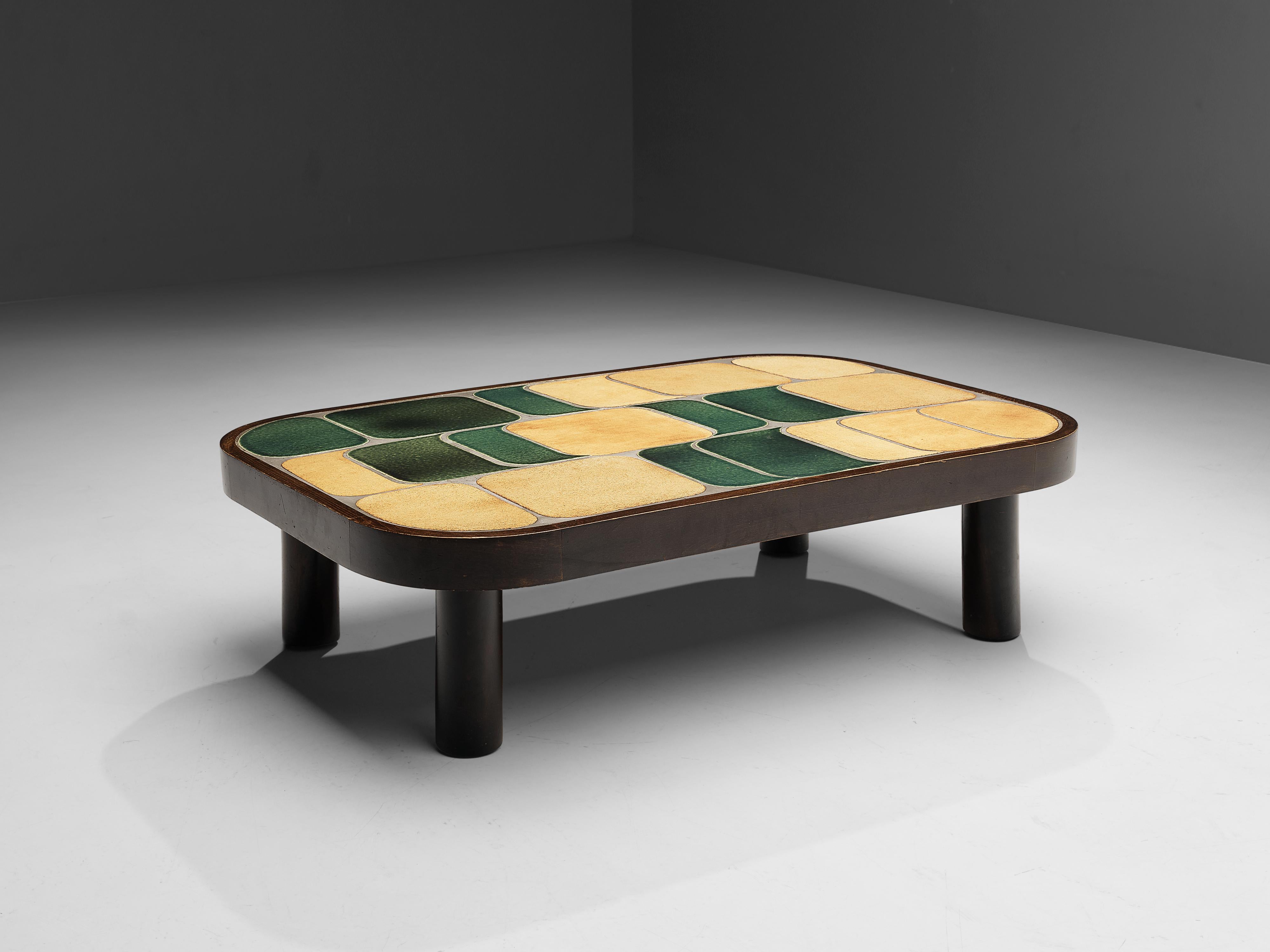 Roger Capron, side table ‘Shogun’, bicolor ceramic, mahogany, France, 1960s

French coffee table with wonderful composed ceramic tiles by French designer Roger Capron. Both the tiles as well as the frame feature rounded corners. The tiles have