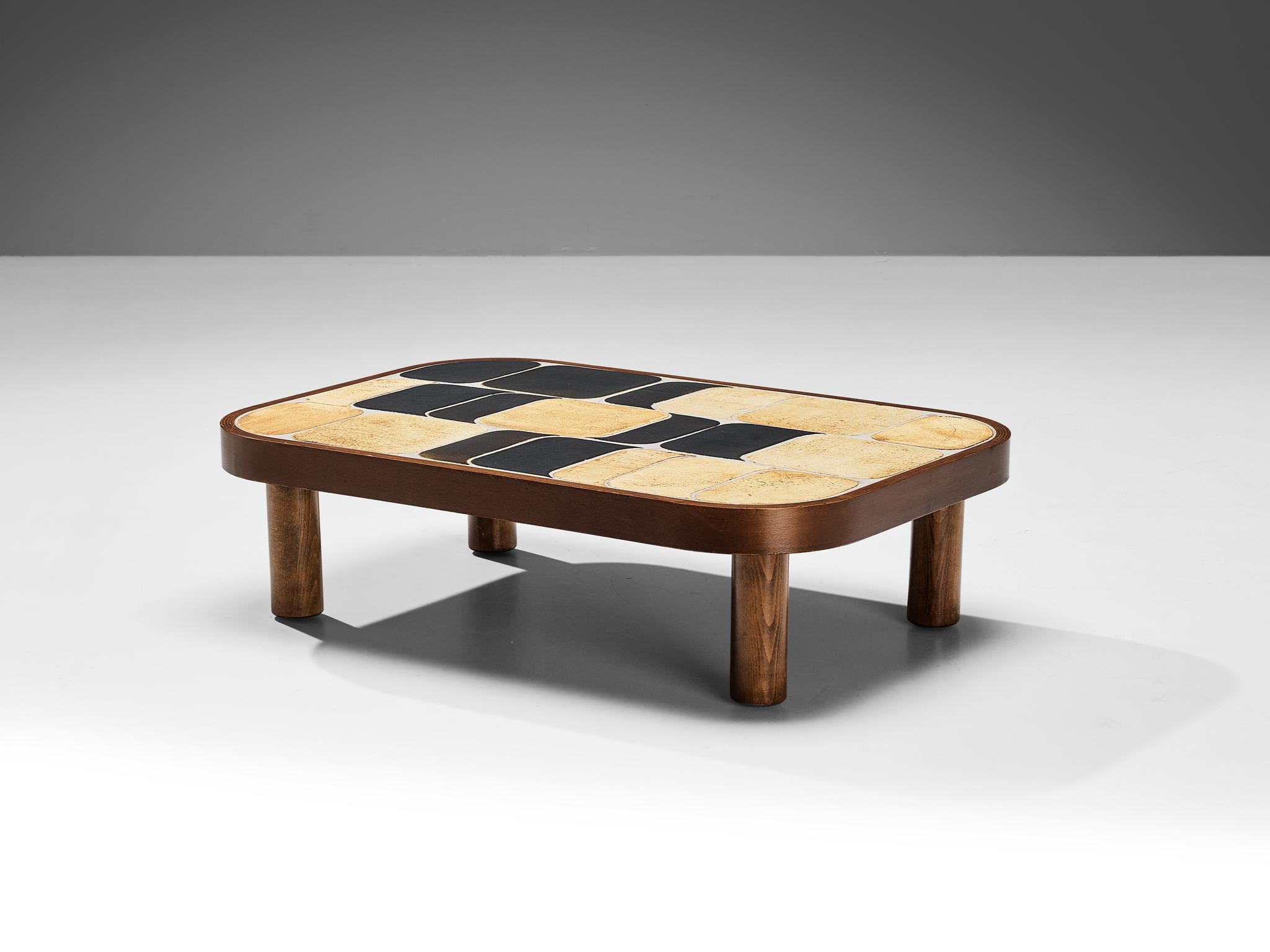 Roger Capron, coffee table, ceramic, stained mahogany, stained beech, France, 1960s.

French coffee table with wonderful composed ceramic tiles by French designer Roger Capron. Both the tiles as well as the frame feature rounded corners. The tiles