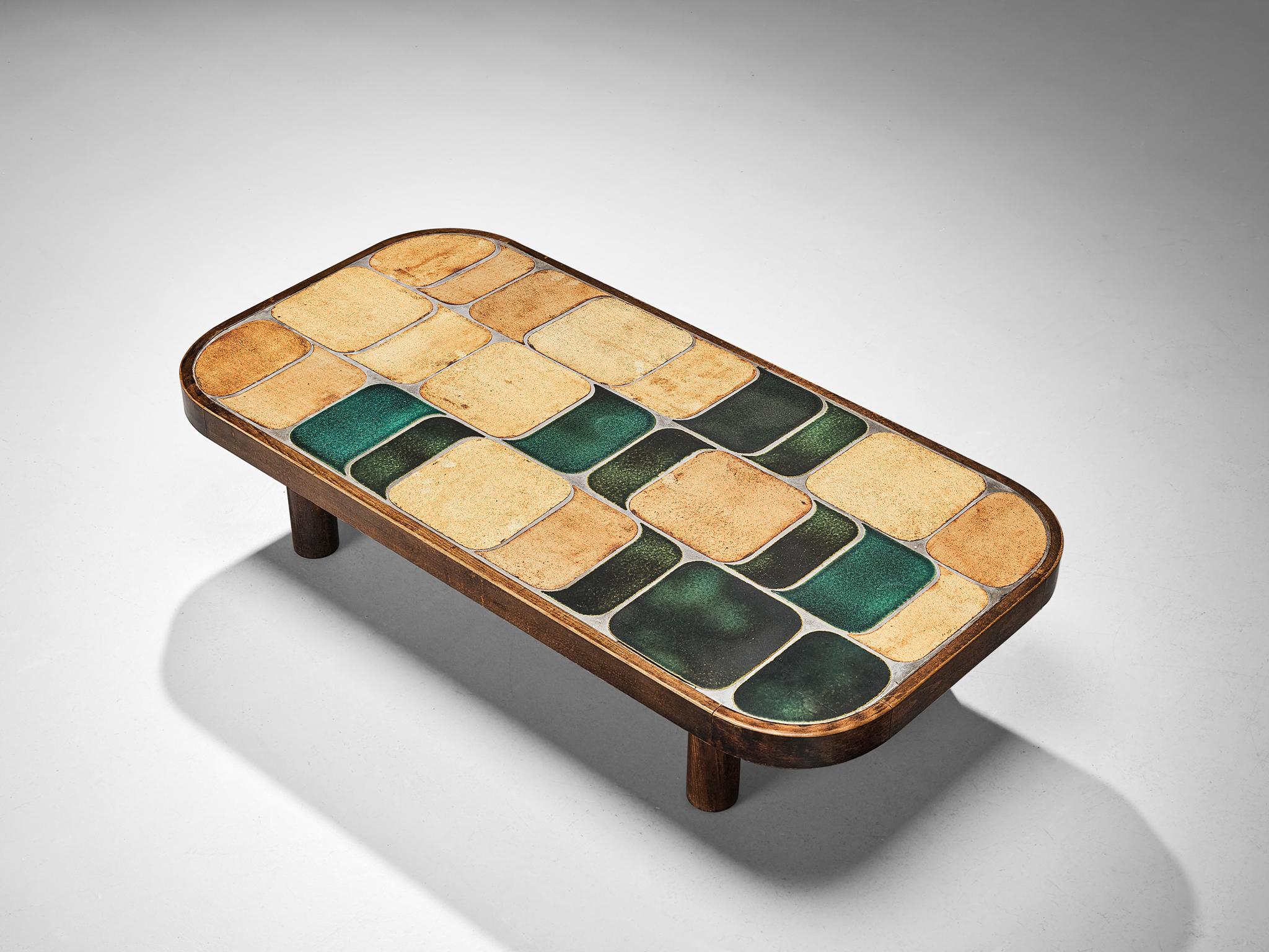 Roger Capron, coffee table, ceramic, stained beech, France, 1960s

French coffee table with wonderful composed ceramic tiles by French designer Roger Capron. Both the tiles as well as the frame feature rounded corners. The tiles have different