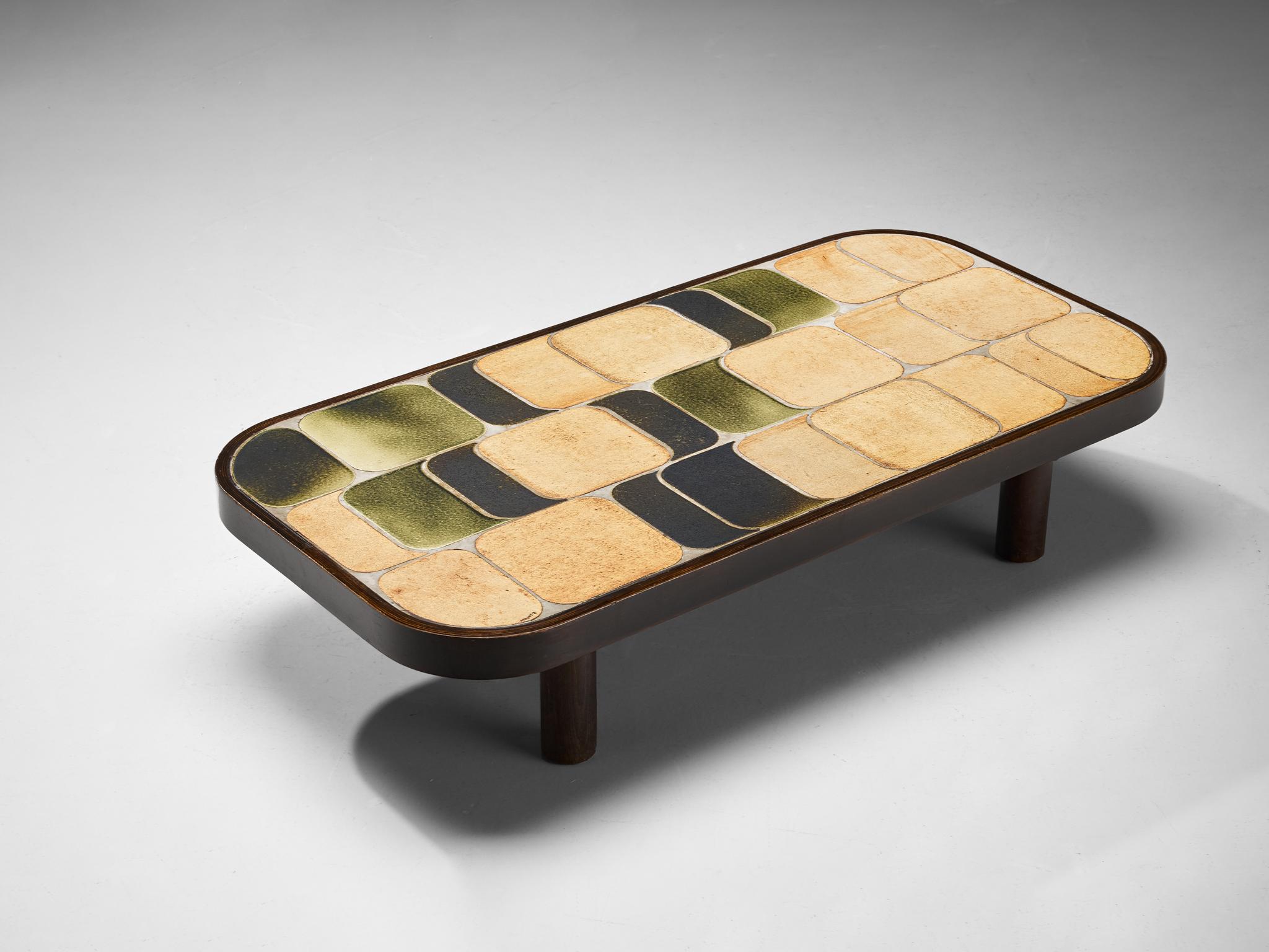Roger Capron, coffee table, ceramic, stained beech, France, 1960s

Lovely French coffee table with wonderful composed ceramic tiles by French designer Roger Capron. Both the tiles as well as the frame feature rounded corners. The tiles have