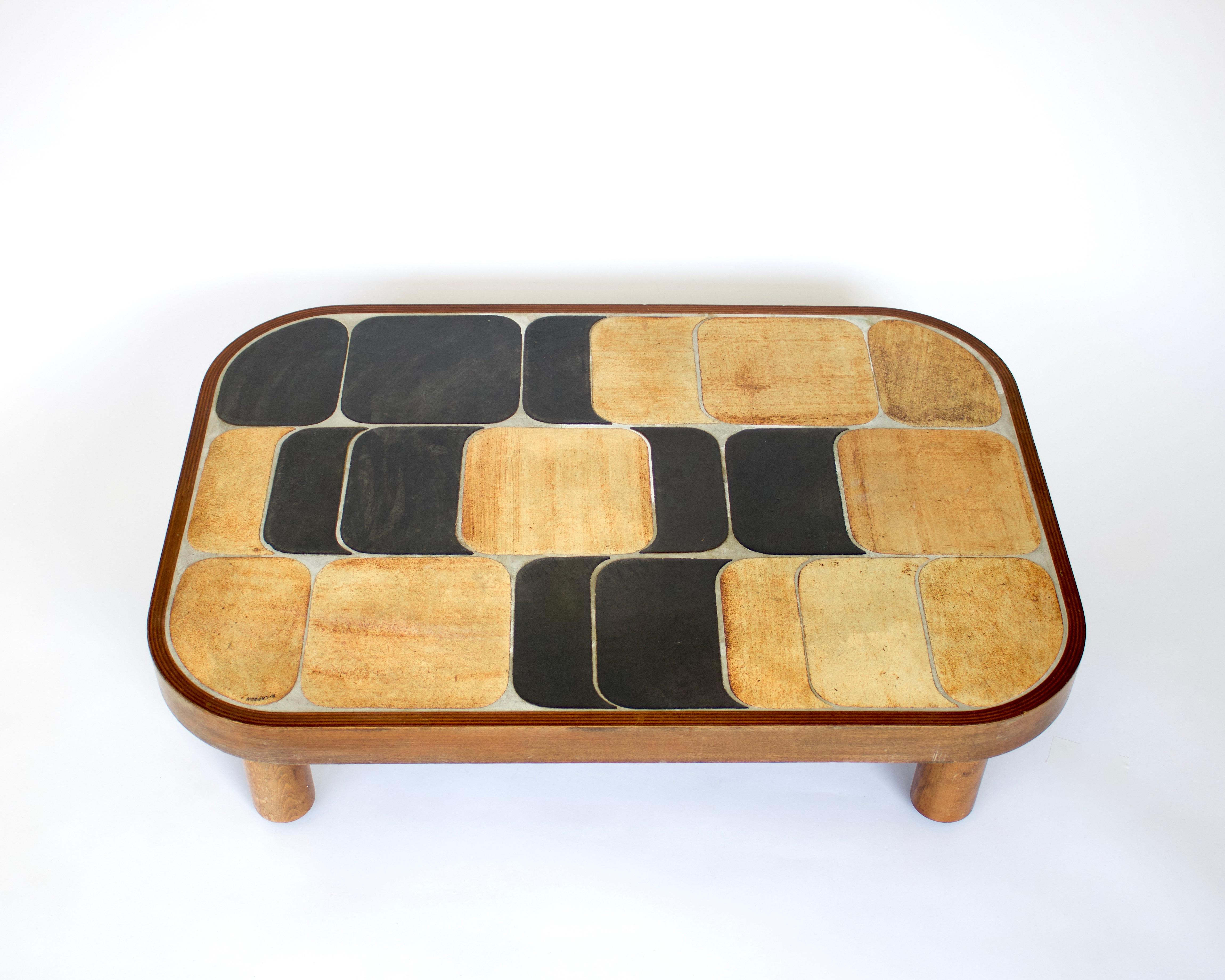 Roger Capron Sho-Gun or Shogun model coffee table with ceramic tile top with beige brown enameled tiles on mahogany base and feet. Signed R Capron.
The colors vary from table to table as a result of the temperature of the firing in the kiln. No