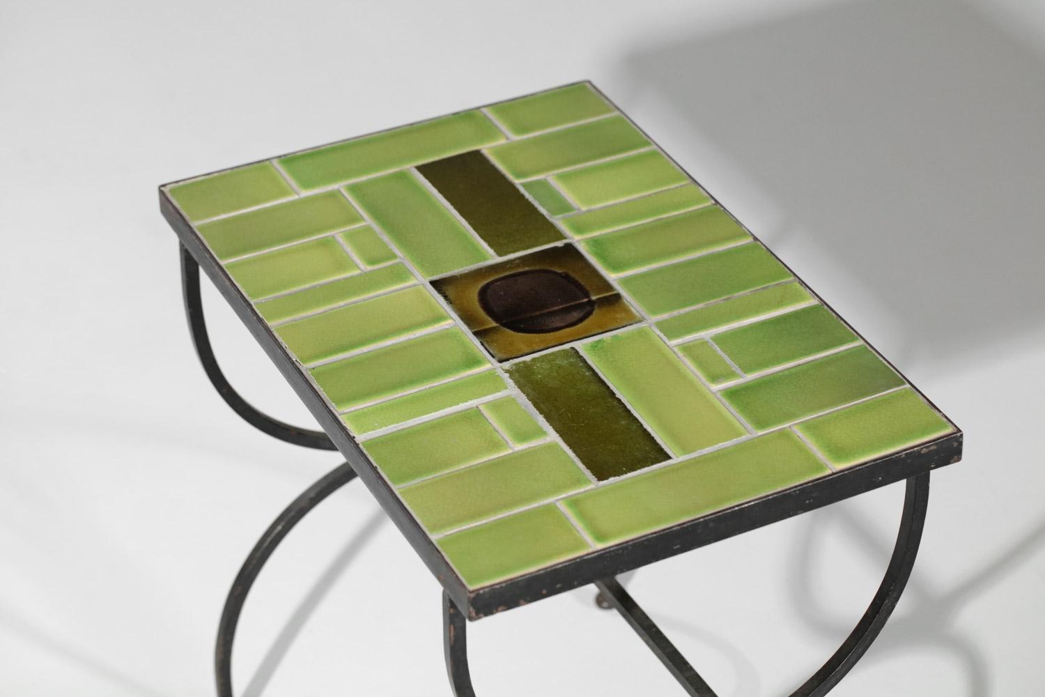 Small coffee table or side table of the French ceramist Roger Capron from the 60's. Structure of the base in black lacquered metal and top made with glazed tiles in green and brown tones in the center. Very nice vintage condition, note the presence