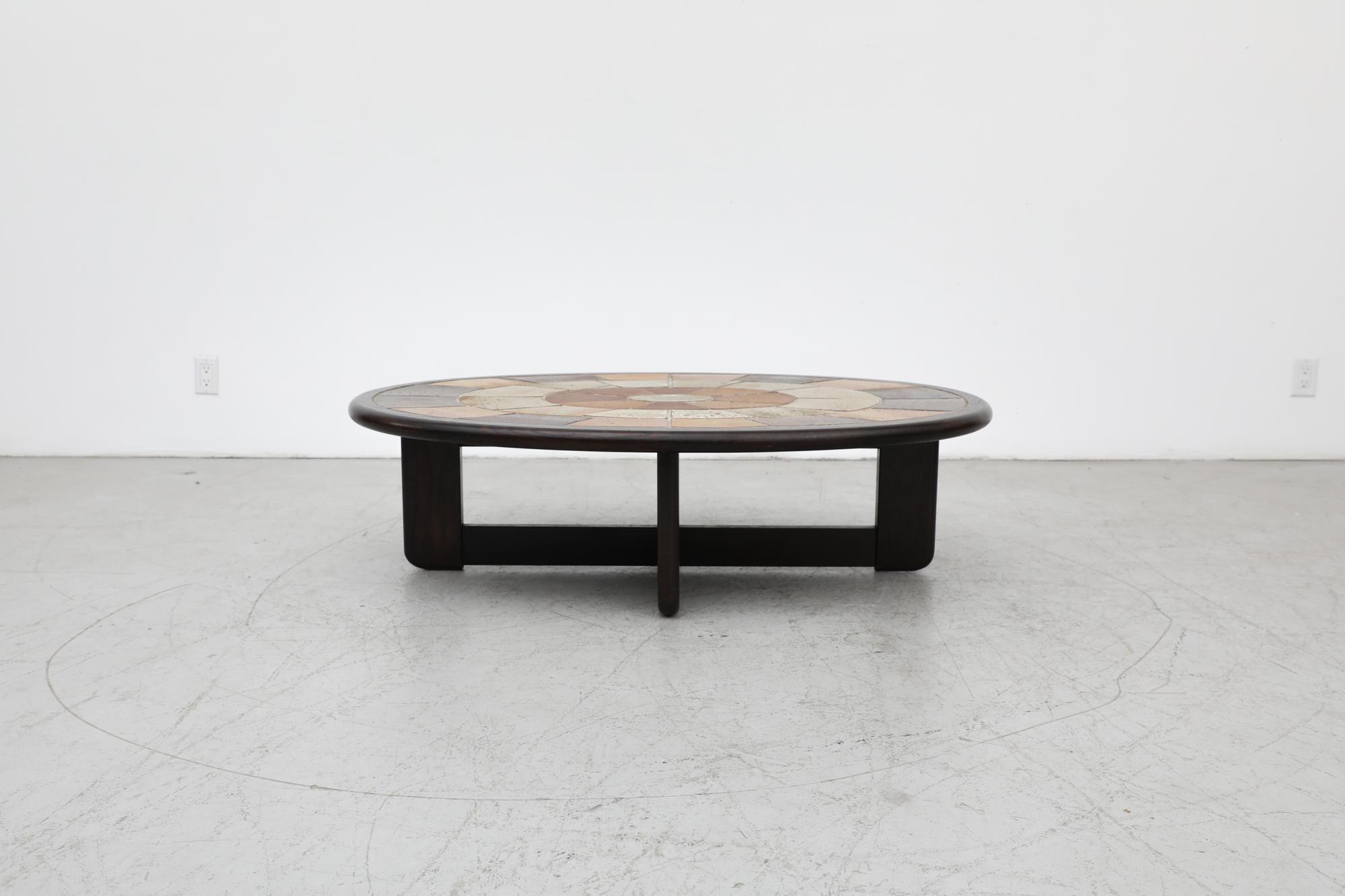 Mid-Century oval ceramic tile coffee table by Tue Poulsen for Haslev Mobelsnedkeri. Roger Capron style 1960's Danish artisan coffee table with ceramic inset tiles and a sold oak frame. Tue Poulsen, mostly known as a sculptor and ceramicist, designed