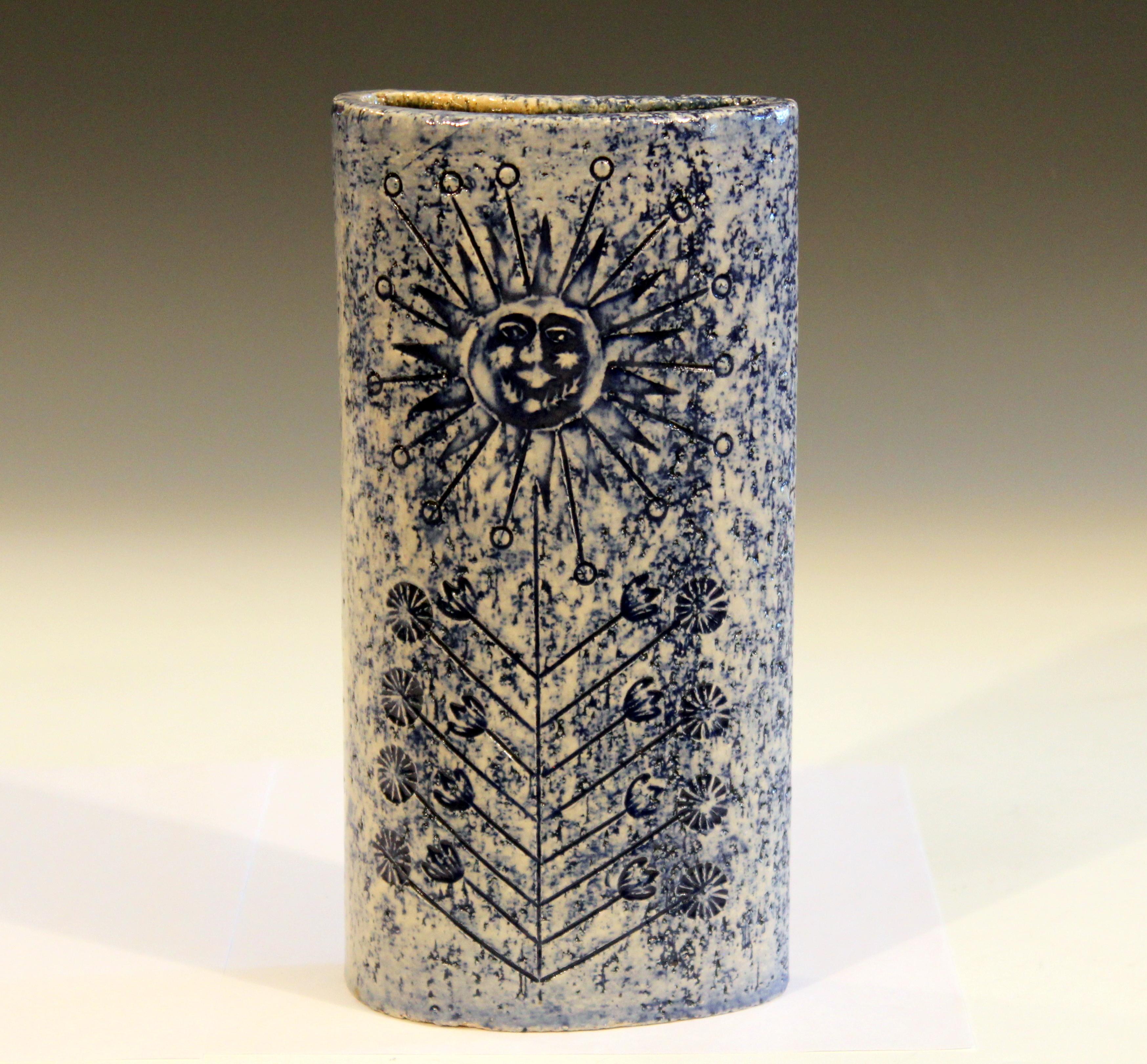 Vintage Roger Capron flower vase with impressed sun face design and attractive blue glaze from the studio in Vallauris, circa 1950s. Measures: 10