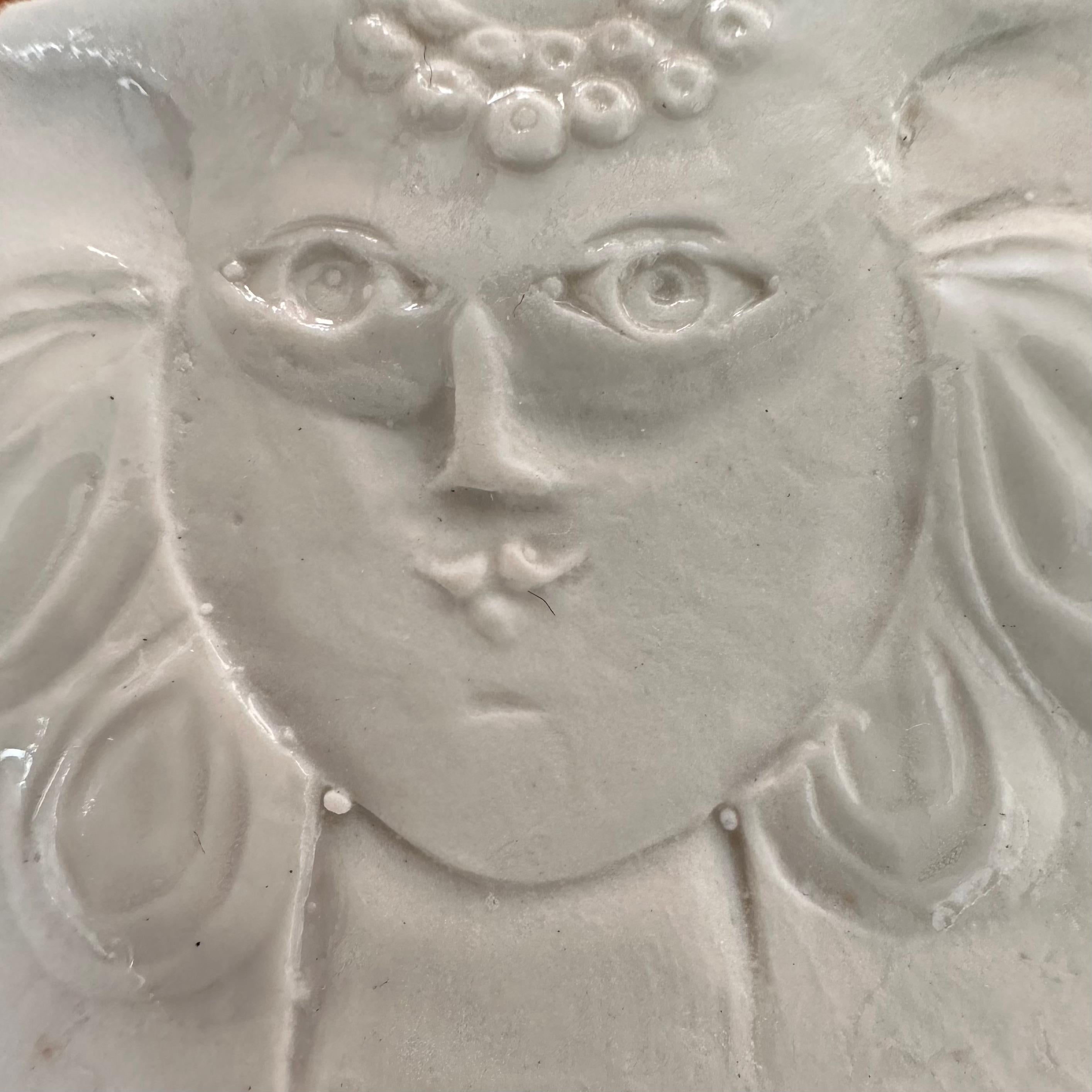 Thin sheet of partially glazed stamped porcelain with the motif of a female figure embodying the Taurus sign.

Rare item from a limited series created by the artist in 1973 around the zodiac signs.

Although unsigned, this delicate artist's jewel is