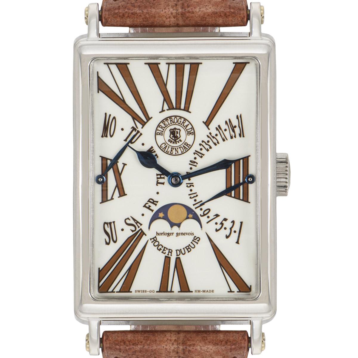 A classic Bi-Retrograde 34mm wristwatch by Roger Dubuis crafted in white gold. Featuring a cream dial with roman numerals, a date and day display as well as a moon phase indicator. Fitted with a scratch-resistant sapphire crystal and powered by a