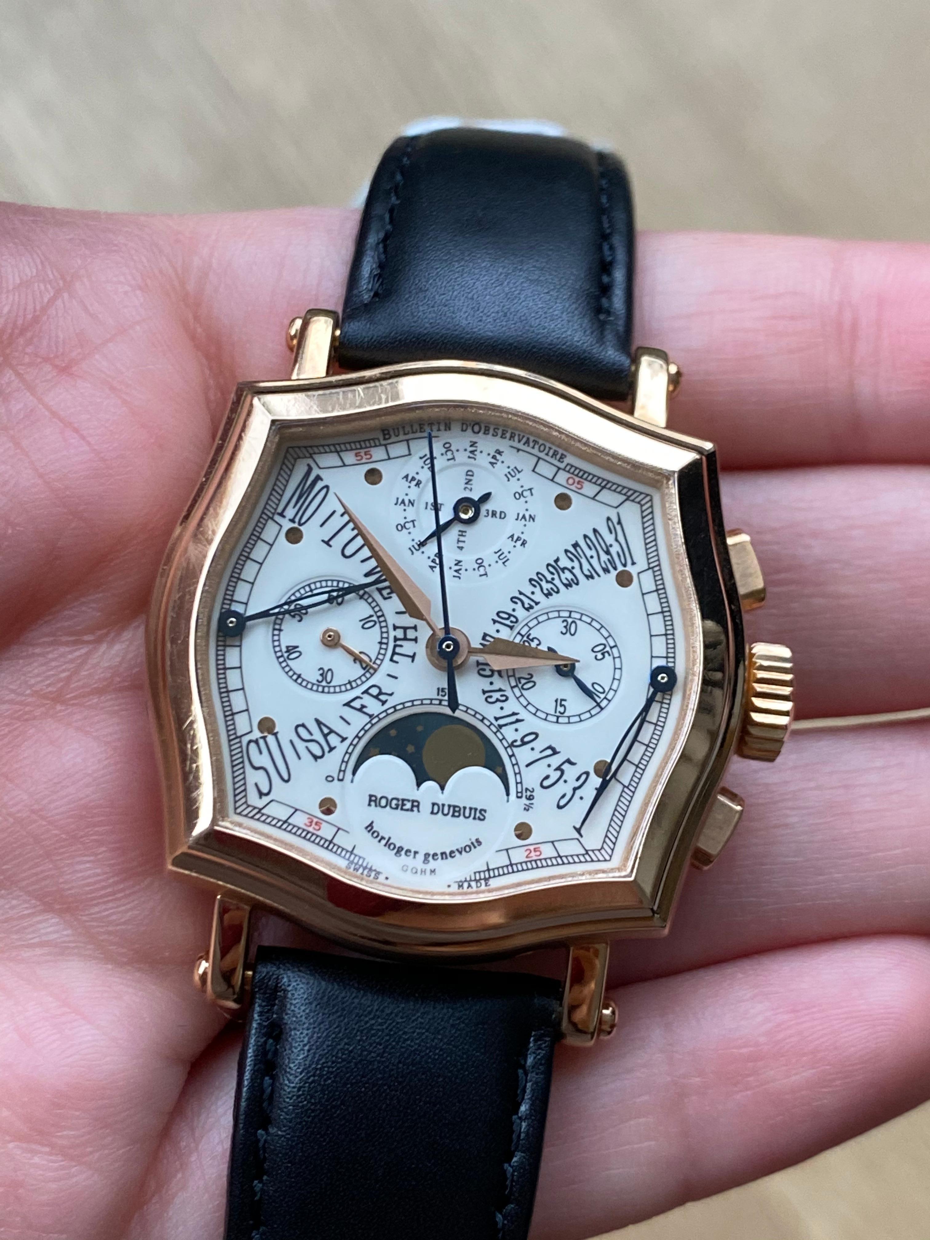 The Roger Dubuis Sympathie Perpetual Calendar Biretrograde (N.24 RD5637 S34) is encased in a 34 mm of rose gold surrounding a white dial on a black genuine calfskin strap (not stamped RD). Features of this Roger Dubuis includes Geneva Hallmark