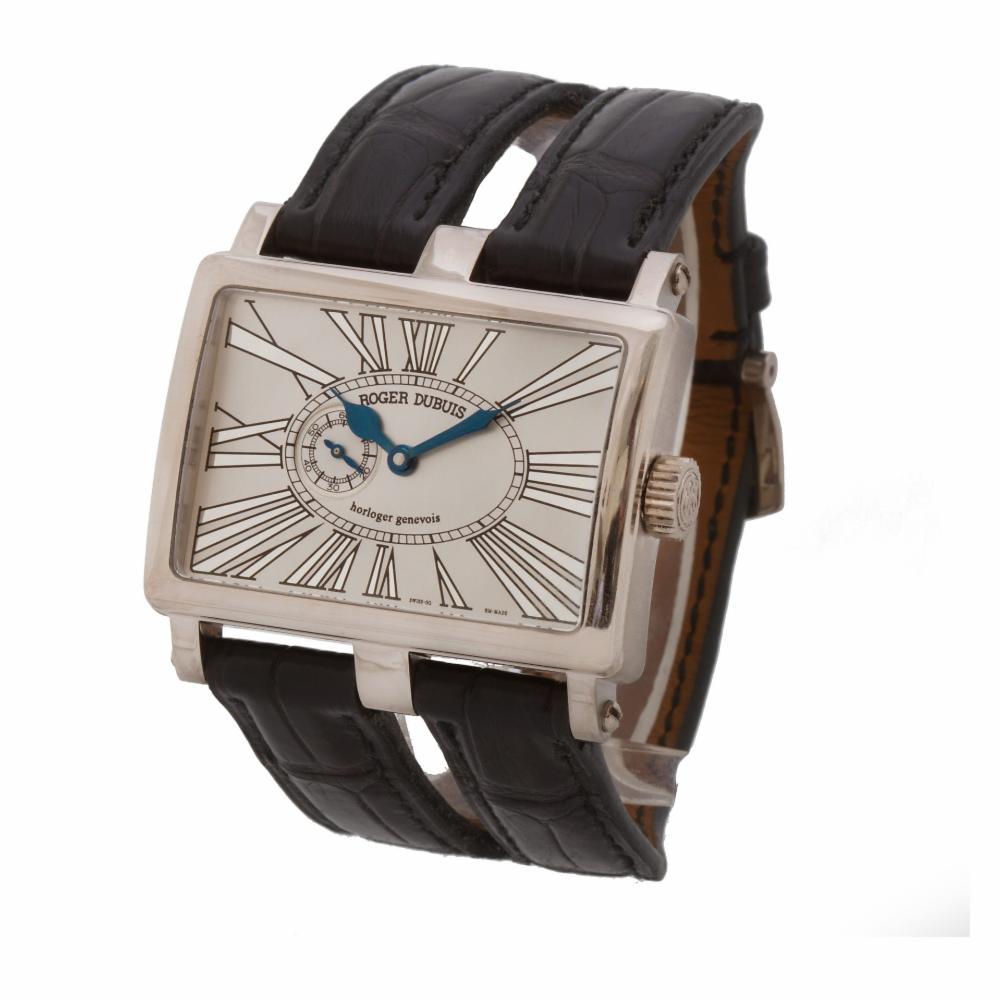 Roger Dubuis Too Much in 18k white gold on leather strap. Manual wind. Case size 43mm x 31mm. Ref T31. Circa 2000s. Fine Pre-owned Roger Dubuis Watch. Certified preowned Dress Roger Dubuis Too Much T31 watch is made out of white gold on a Black