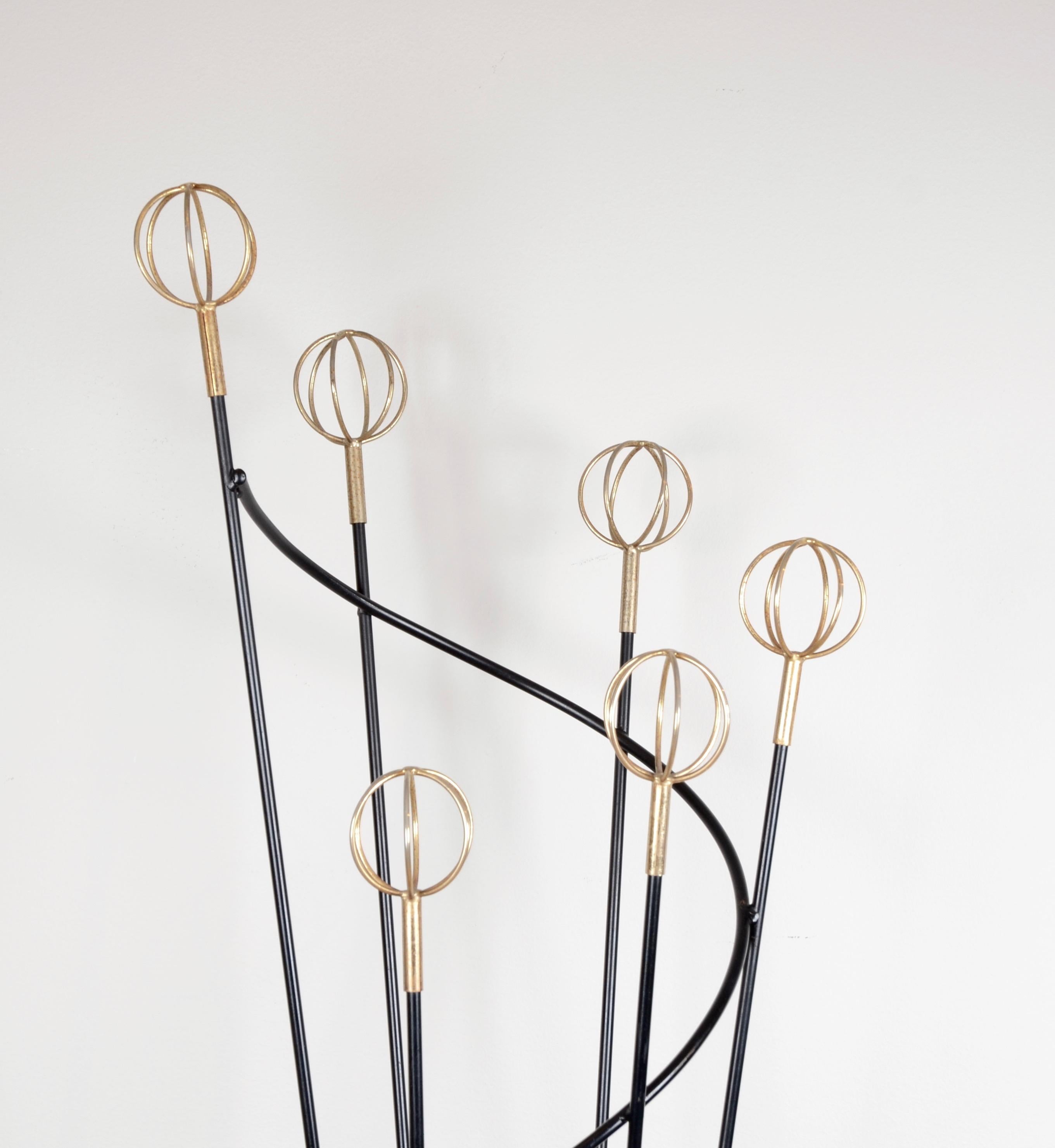 Italian coat hanger in lacquered metal and details in brass, designed by Roger Feraud. Italian, mid-1900s.
