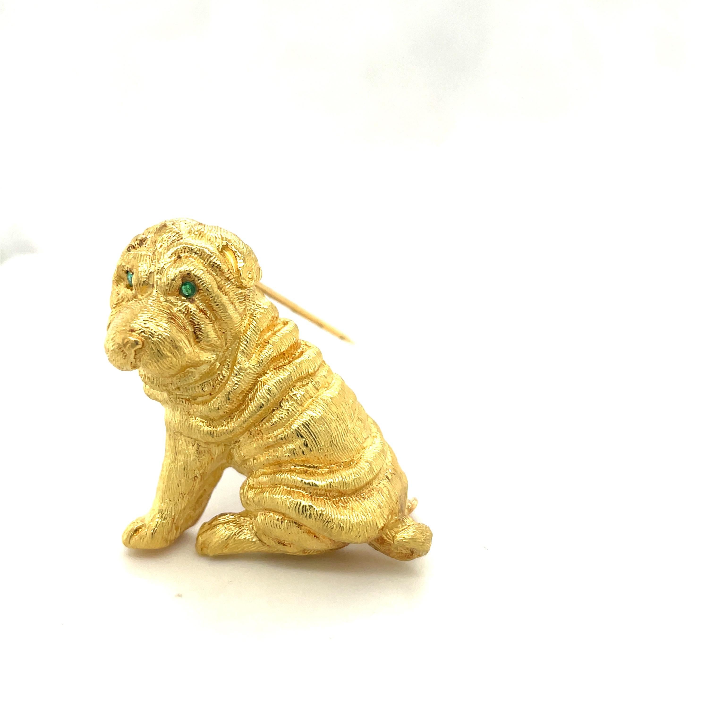 Crafted by Roger Guillochon ,from France for Cellini Jewelers, this 18 karat yellow gold  Shar Pei brooch depicts magnificent craftsmanship. The dog's body is etched in a satin finish. His soulful eyes are set with emeralds . He measures 1.5