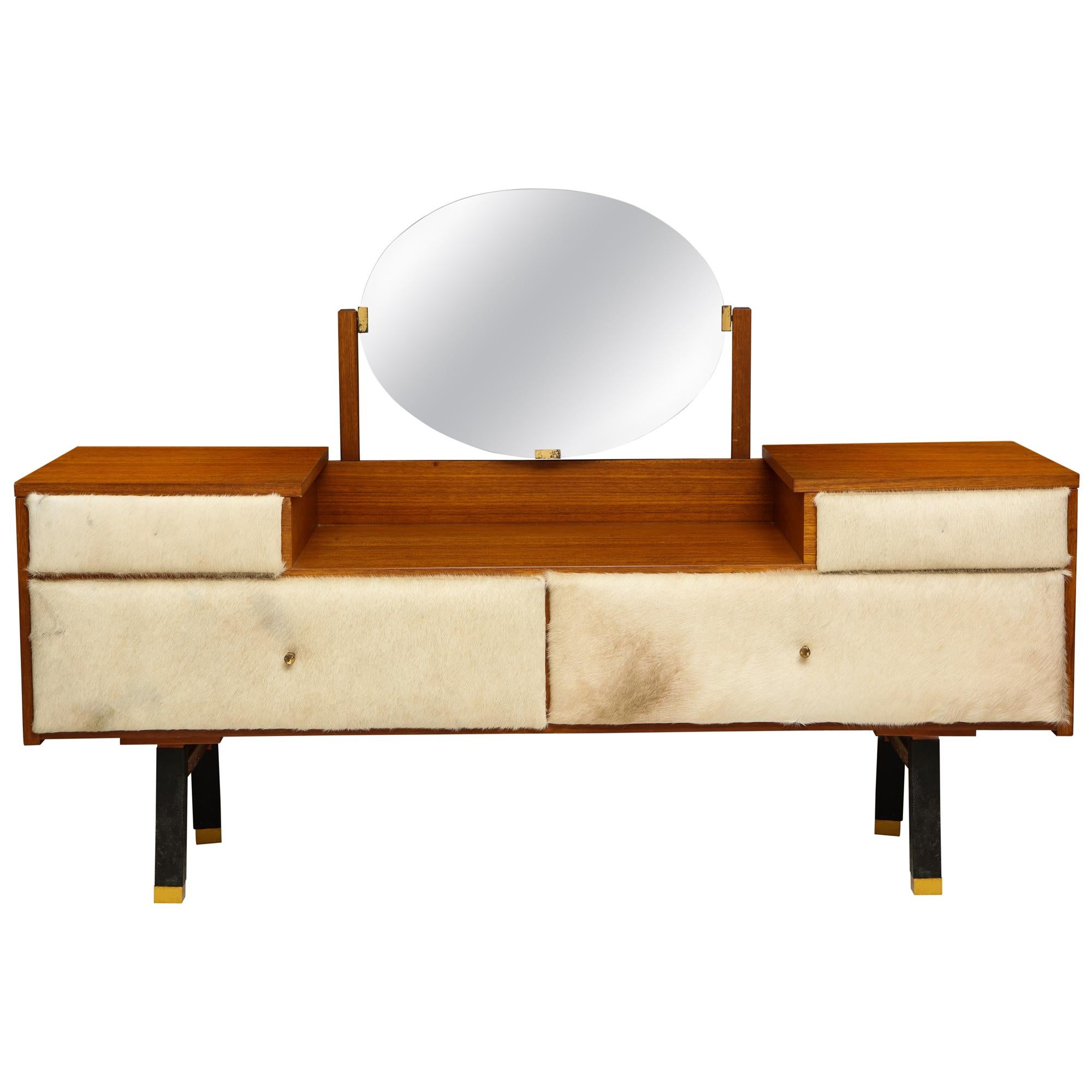 Roger Landault crème cowhide brown wood vanity, modernist, France midcentury, 1950

Beautiful vanity in fantastic vintage condition upholstered in cowhide and brass detailing to the legs. Both top drawers open as well as the bottom drawers for