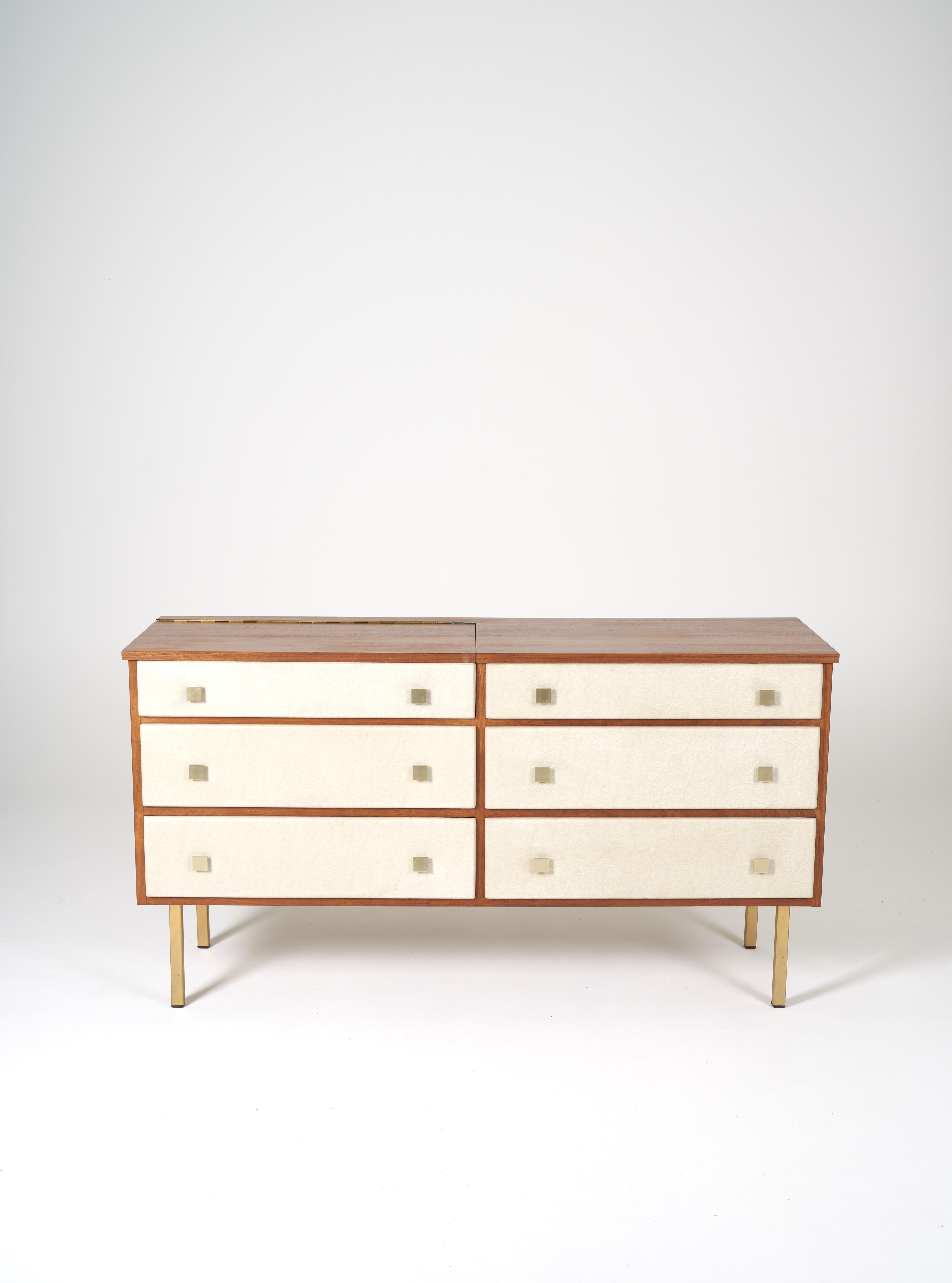Dressing table by Roger Landault, teak structure, five drawers lined with cream imitation leather and lid revealing a mirror. Legs and handles in brass of square shape. Circa 1960. Exceptional in this state restoration of the felt of the top drawer.