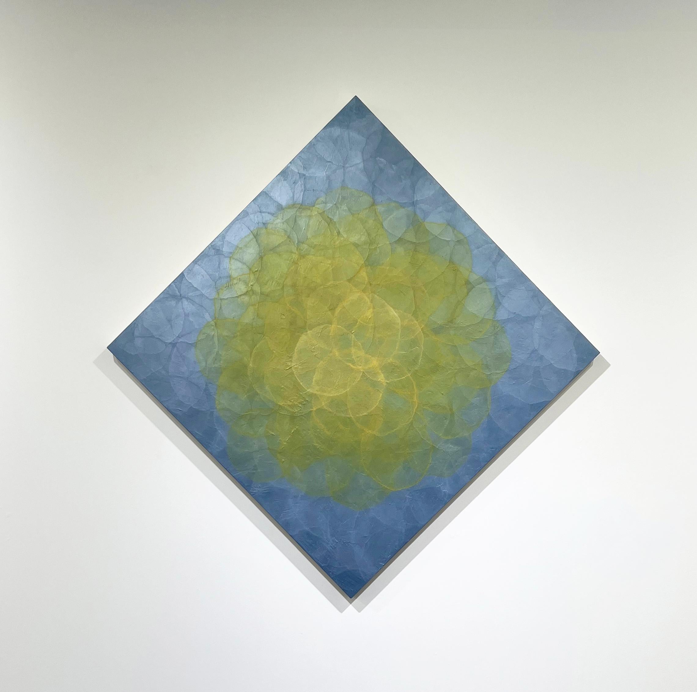 This abstract painting by Roger Mudre is made with acrylic paint over marble dust and mica powder on cradled birch panel. It features a vibrant palette with small concentric circles composing a larger yellow circle at the center of the composition,