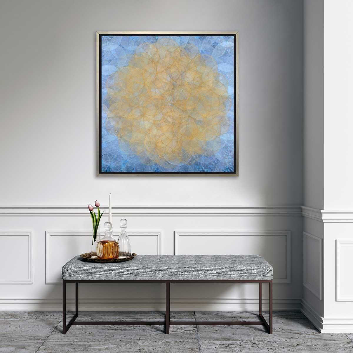 This abstract geometric limited edition print by Roger Mudre features lightly translucent concentric circles that overlap throughout the composition, creating a glowing effect of a yellow-gold circle at the center, surrounded by a light blue