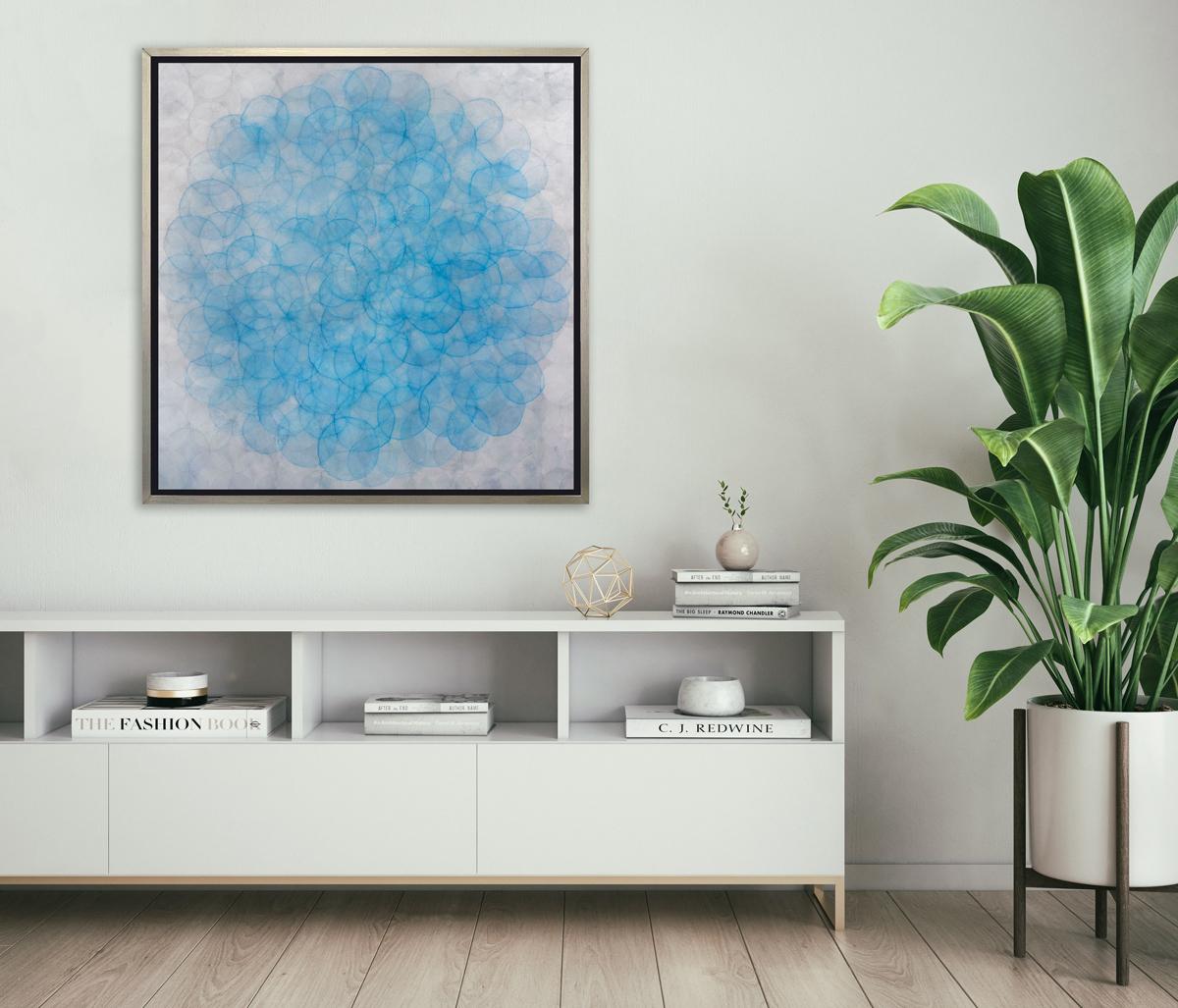 This abstract limited edition print by Roger Mudre features light circle shapes, layered over one another in a concentric fashion and a cool blue and silvery grey palette. This Limited Edition giclee print is an edition size of 25. Printed on