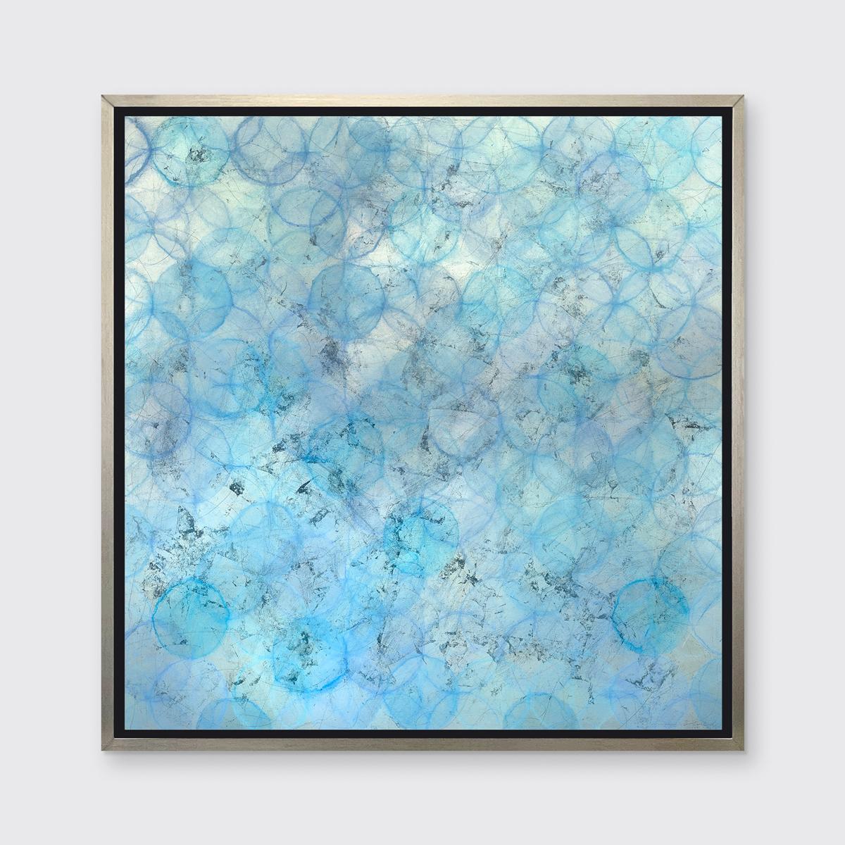 This abstract limited edition print by Roger Mudre features a light blue and silver palette, with warm, subtle pops of lavender layered throughout. Light outlined circular shapes are layered over one another and span out past the edges of the