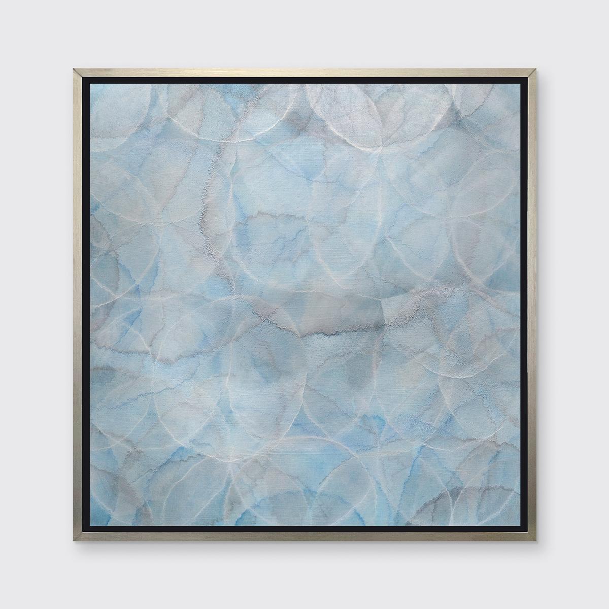 This abstract limited edition print by Roger Mudre features a cool blue, grey, and silver palette. The artist layers light outlines of circles over one another, which have an almost glowing aesthetic, which reaches out to all edges of the