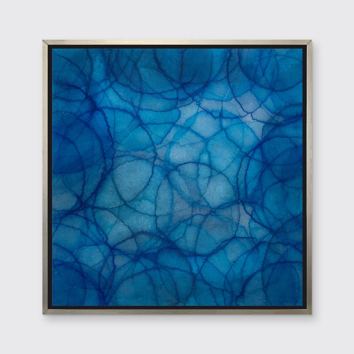 This Limited Edition giclee print by Roger Mudre features features a cool-toned palette with an iridescent quality. Circles with light outlines overlap one another in varying blue, green, white shades to create a larger blue circular form at the