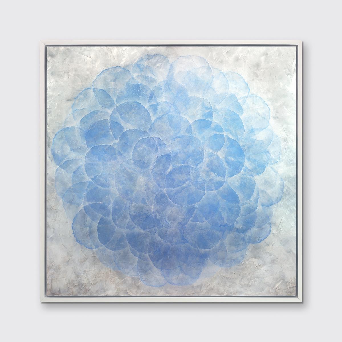 This Limited Edition giclee print by Roger Mudre features nearly transparent light blue circles, arranged in an overlapping pattern to create a larger circle shape. The outer layer of the circle blends into the surrounding silver-grey background and
