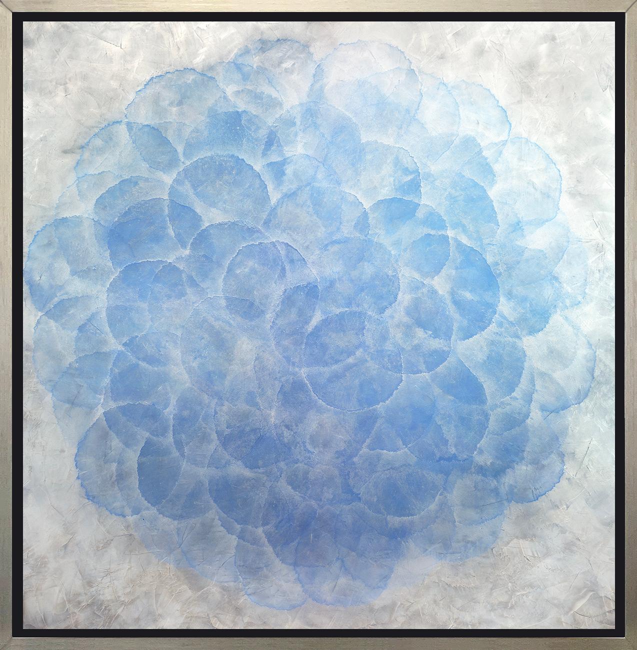 This Limited Edition giclee print by Roger Mudre features nearly transparent light blue circles, arranged in an overlapping pattern to create a larger circle shape. The outer layer of the circle blends into the surrounding silver-grey background and