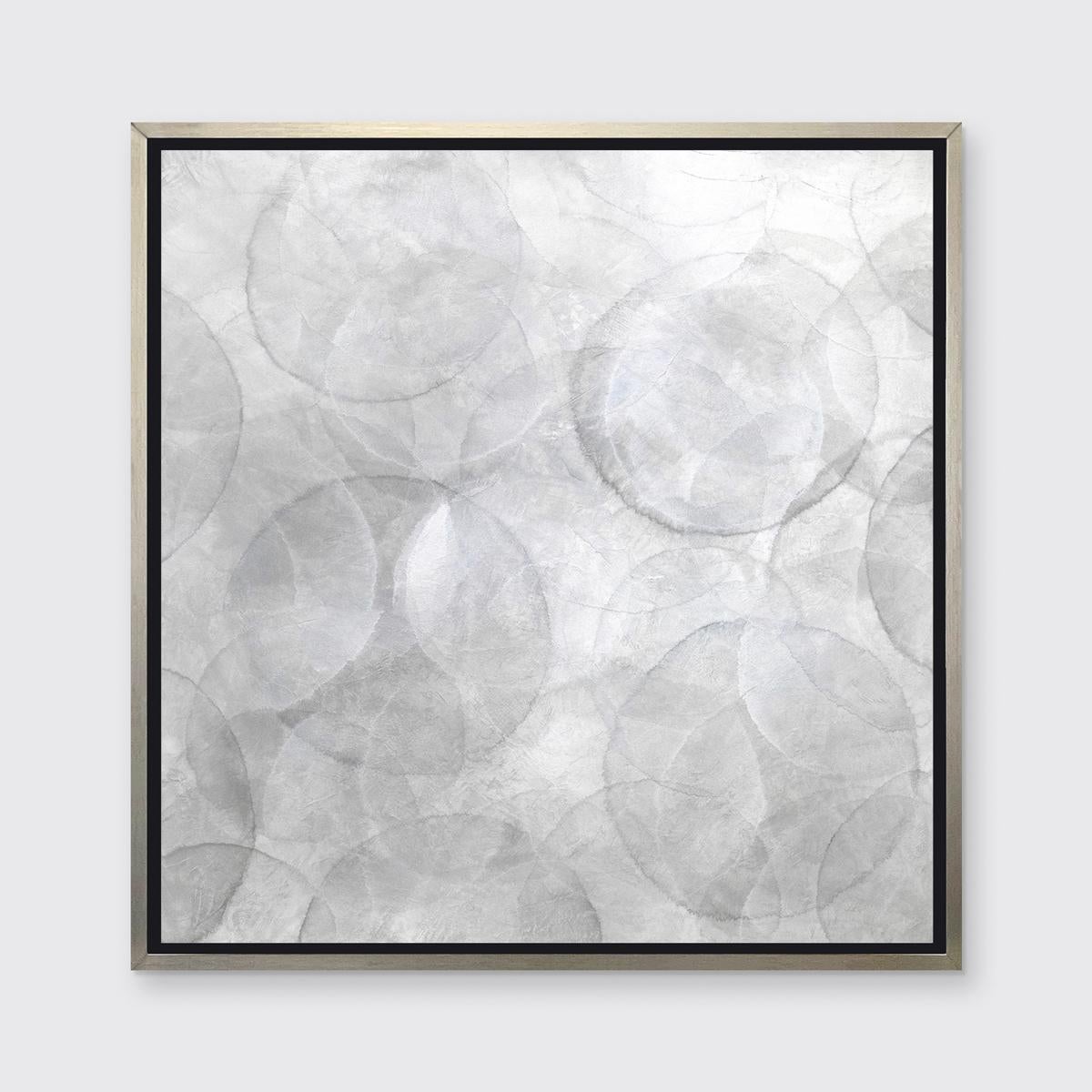 This Limited Edition giclee print by Roger Mudre features a light, silvery palette. Loose, transparent circular shapes are layered and patterned overtop of one another in different shades of grey. It is an edition size of 25. Printed on canvas, this