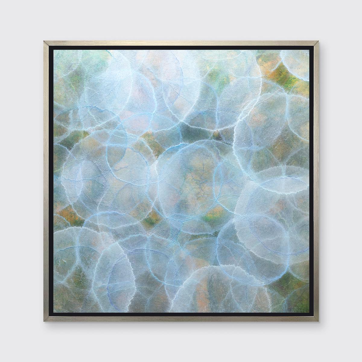 This abstract limited edition print by Roger Mudre features light, translucent circles layered over one another throughout the composition. The under layers are a deep green and yellow, with brighter circles overtop which have a light outline and