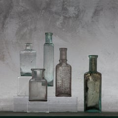 Small Bottles 22, Still Life Photograph of Glass Bottles on Gray