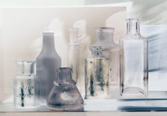 Small Bottles 24a Invert, Still Life Photograph of Glass Bottles in White, Gray