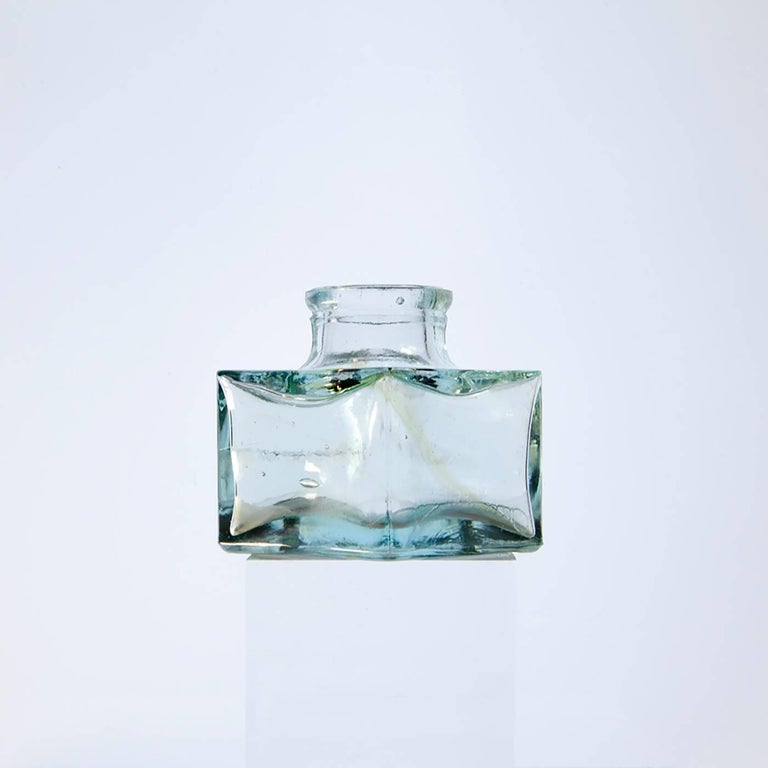 Roger Ricco Still-Life Photograph - Small Bottles Three, Square Still Life Photograph of Glass Bottle on White