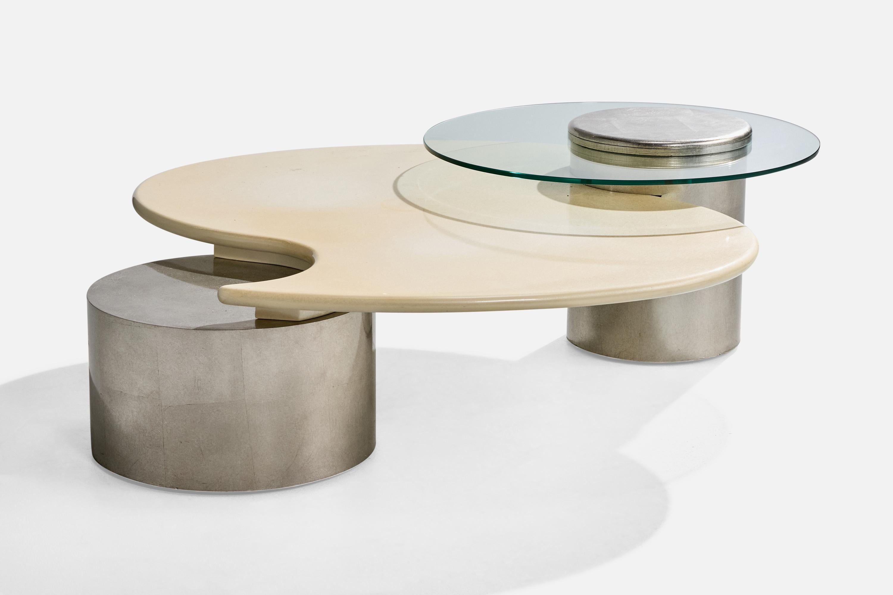 A silver-leafed, beige-lacquered wood and glass coffee table designed and produced by Roger Rougier, Canada, c. 1970s.

Overall Dimensions (inches): 16.25