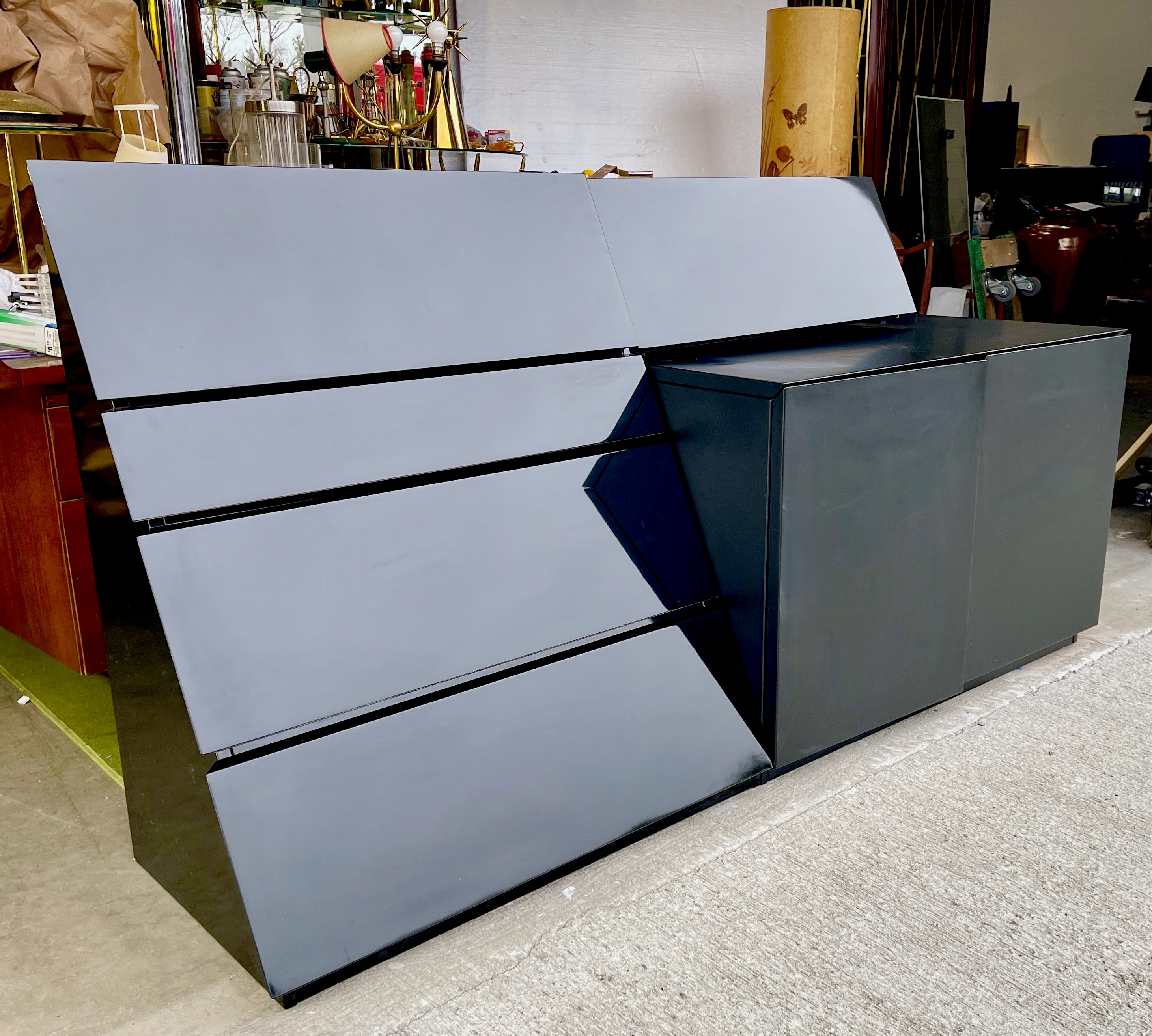 This is a two piece post-modern design by Roger Rougier of Montreal circa 1980 in contrasting geometric and volumetric shapes and finishes which can be used independently but are intended to be used together side by side.
On the left in high gloss