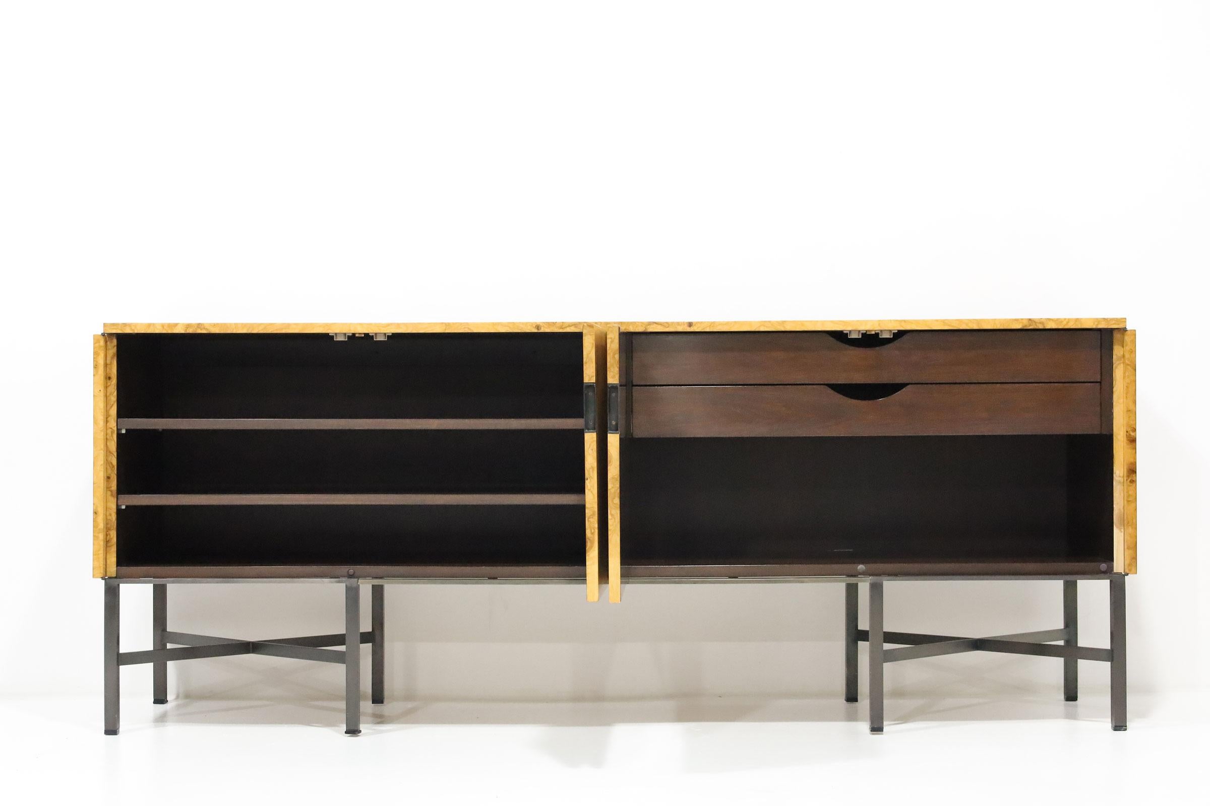 A stunning burled olivewood credenza designed by Roger Sprunger for Dunbar. The credenza features gorgeous wood grain and clean, sleek modern lines. The wood case rests on black metal legs. The cabinet offers ample room for storage. One cabinet