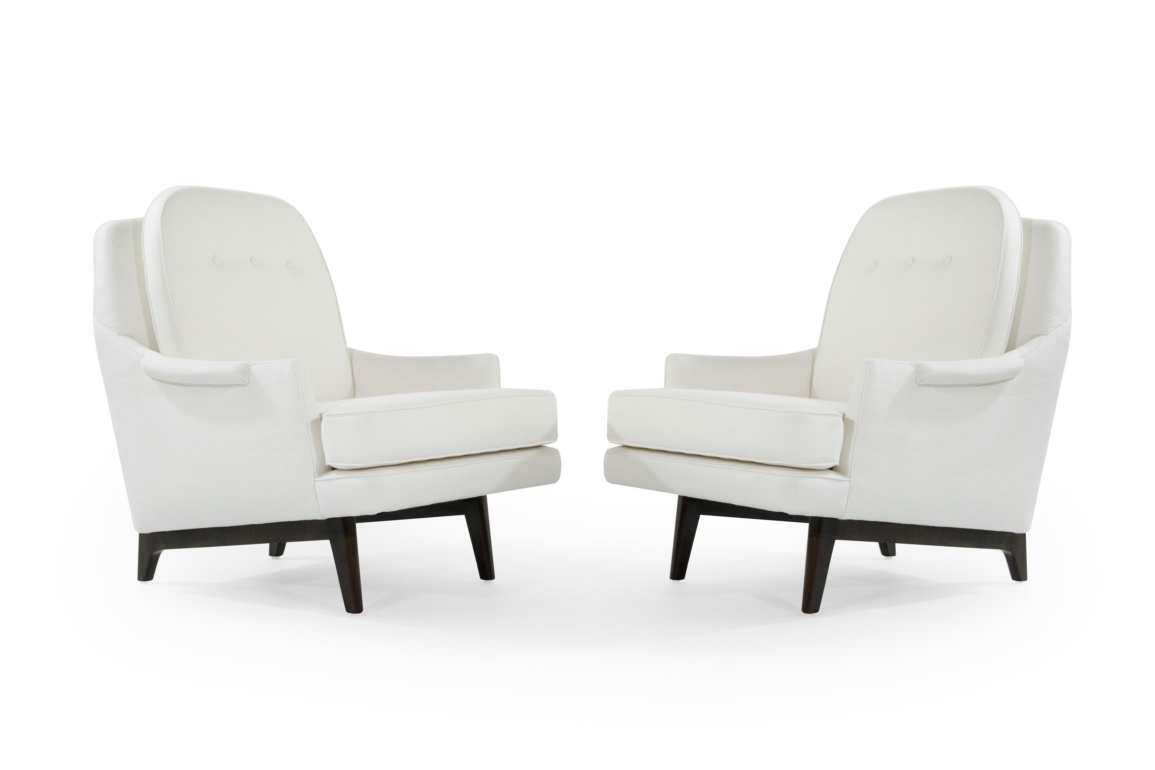 Pair of slopped arm lounges, three button tufted down back, sculptural walnut base, designed by Roger Sprunger for Dunbar, circa 1950s. Very comfortable set, perfect in a library setting.
Newly upholstered in off-white linen.
 