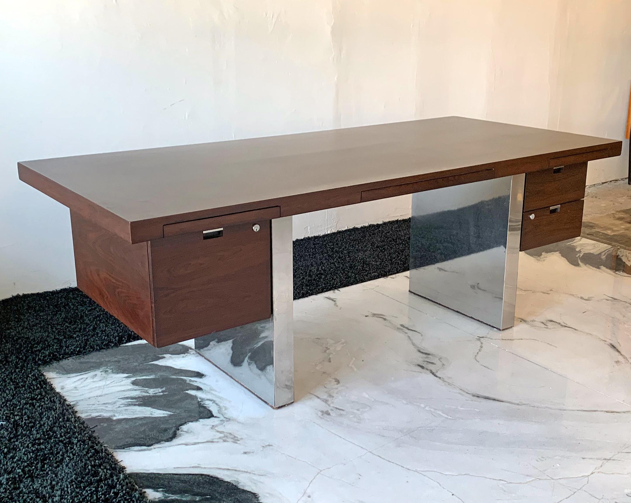 Some pieces of furniture have a vibe all their own; this desk is one of those pieces. Clad in rosewood and polished stainless steel (chrome), this desk epitomizes midcentury luxury. It's bold, timeless design would compliment any type of