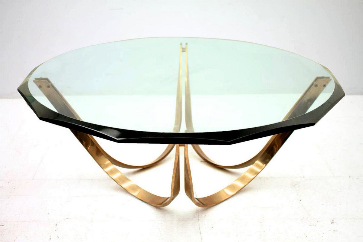 This sculptural cocktail table by Tri-Mark features gold-plated steel with a nice patina and a thick, beveled glass top with twelve facets. We have the top in 48