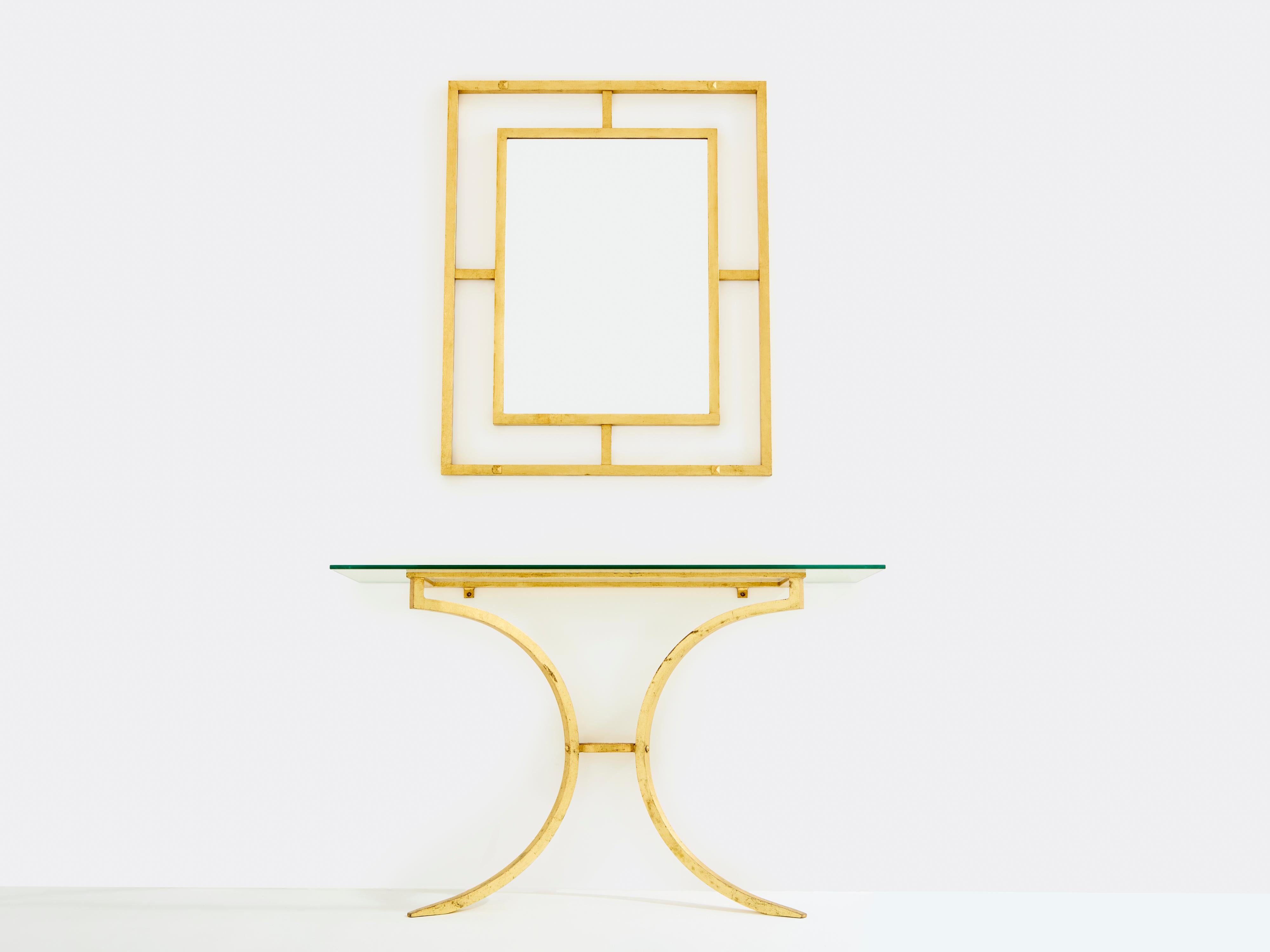 High quality materials, with slick timeless lines, gives this rare console with its matching mirror all its appeal. Wrought iron has been gilded with gold leaf for a gentle warm golden patina throughout the entire structure, including all the