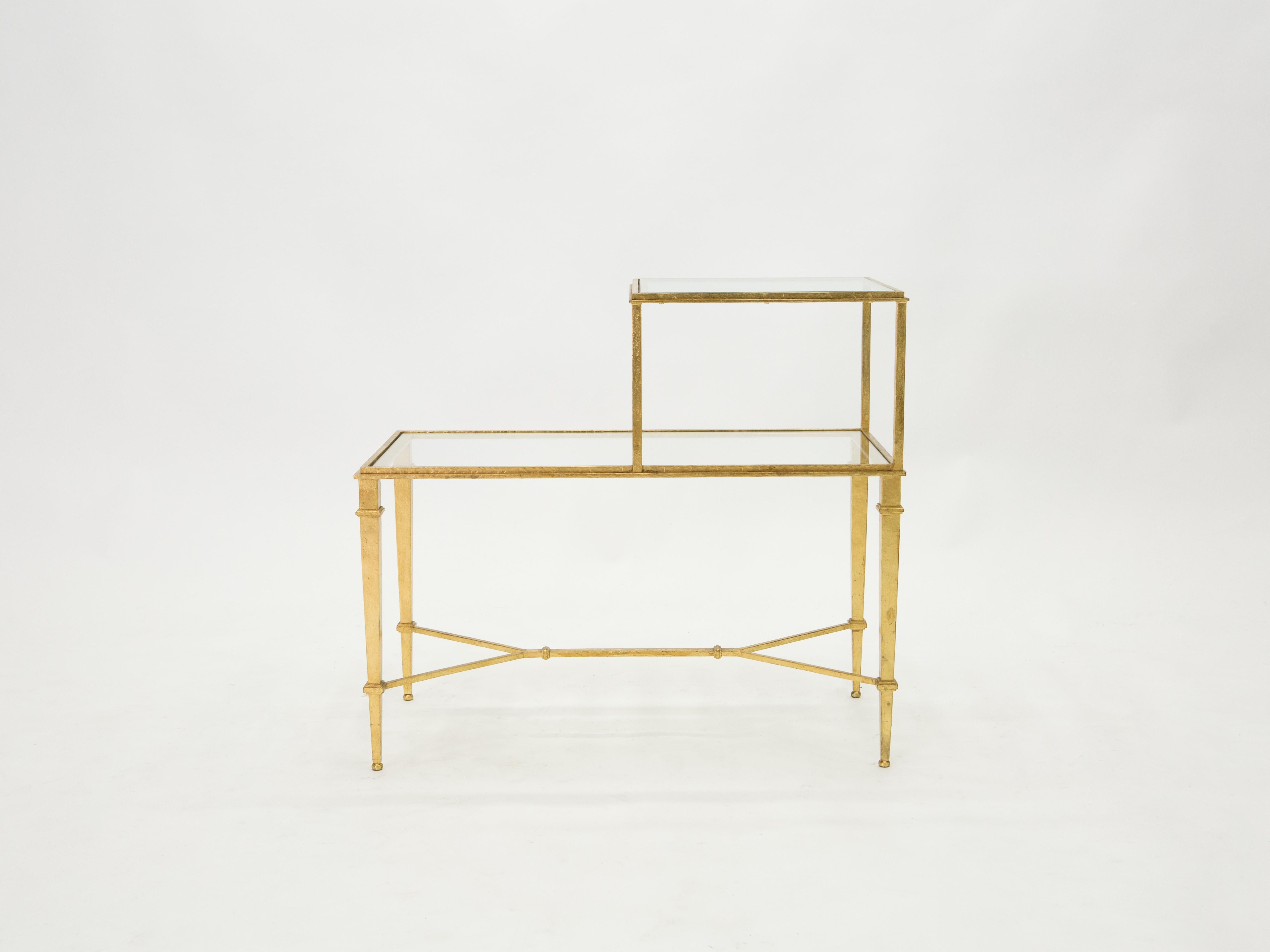 Grace your home with the true elegance of this side or end table signed and stamped by Roger and Robert Thibier in the 1960s. Glittering in an antiqued gold gilt finish, this original two-tier iron Craft side table adds a glam twist which makes a