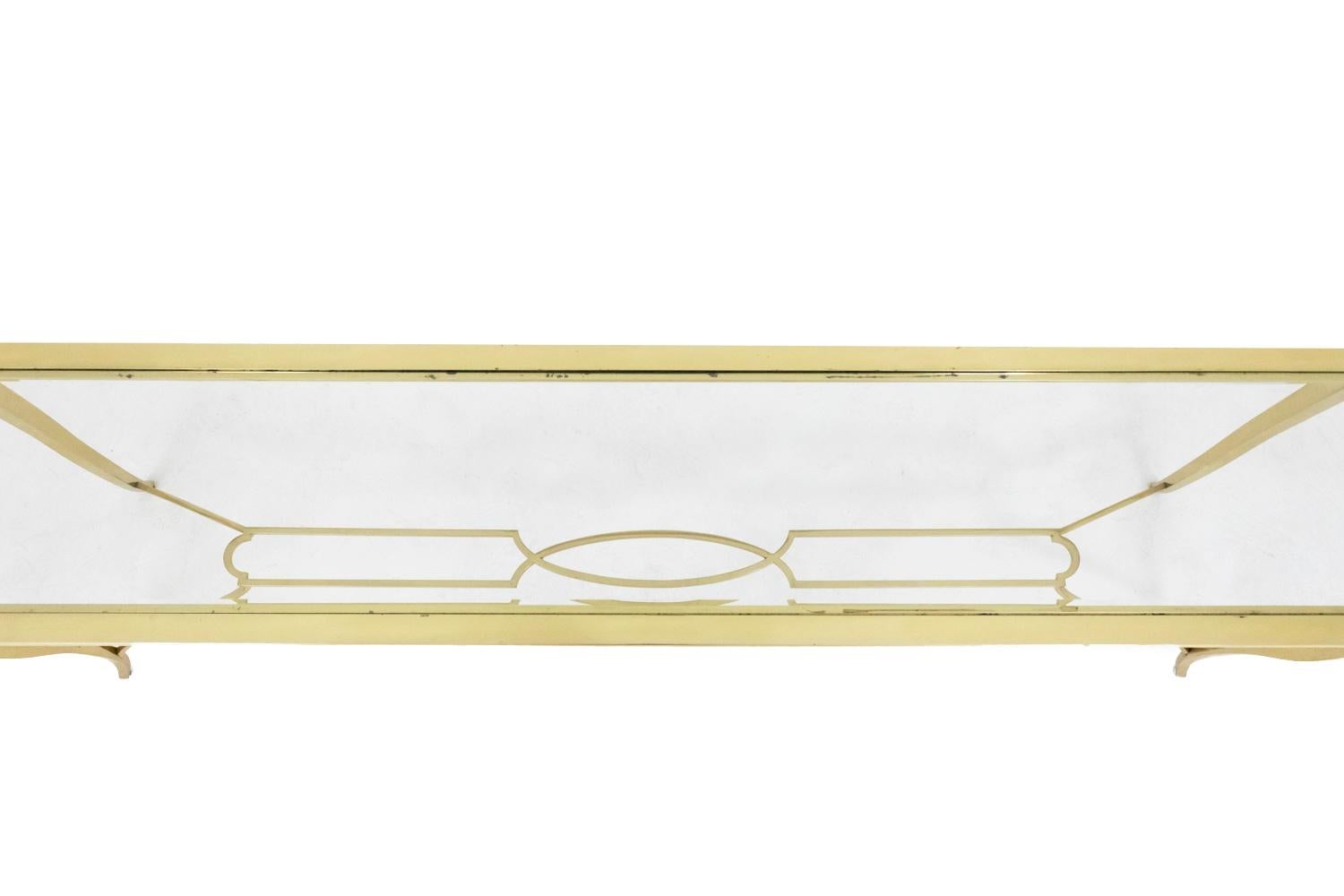 Large rectangular gilt brass console standing on four bulged legs linked each other by a tormented stretcher composed of oblong twisted medallions in the middle part. 
Rectangular tray in transparent glass.

Work in the 1940s style, realized in