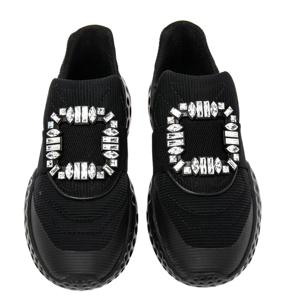 Look your stylish best every time you step out wearing these Sneaky Viv sneakers from the House of Roger Vivier. They are made from black canvas on the exterior with a crystal-embellished motif perched on their vamps. They are made in a slip-on