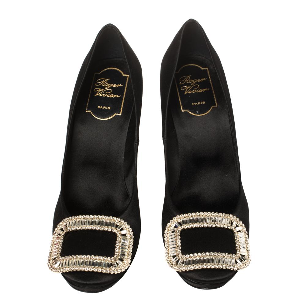 Roger Vivier is well-known for its graceful designs, and the label is synonymous with opulence, femininity, and elegance. These pumps are crafted from satin in a black shade into an almond toe silhouette augmented by the embellishments perched on