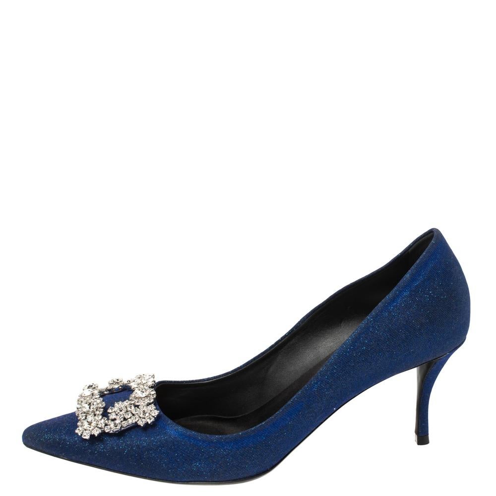 Astoundingly beautiful, these pumps are by Roger Vivier. Styled in blue glitter fabric with dazzling floral crystal embellishments on the toes and satin insoles to provide comfort, these luxurious pumps will never fail to lift your outfits. Complete
