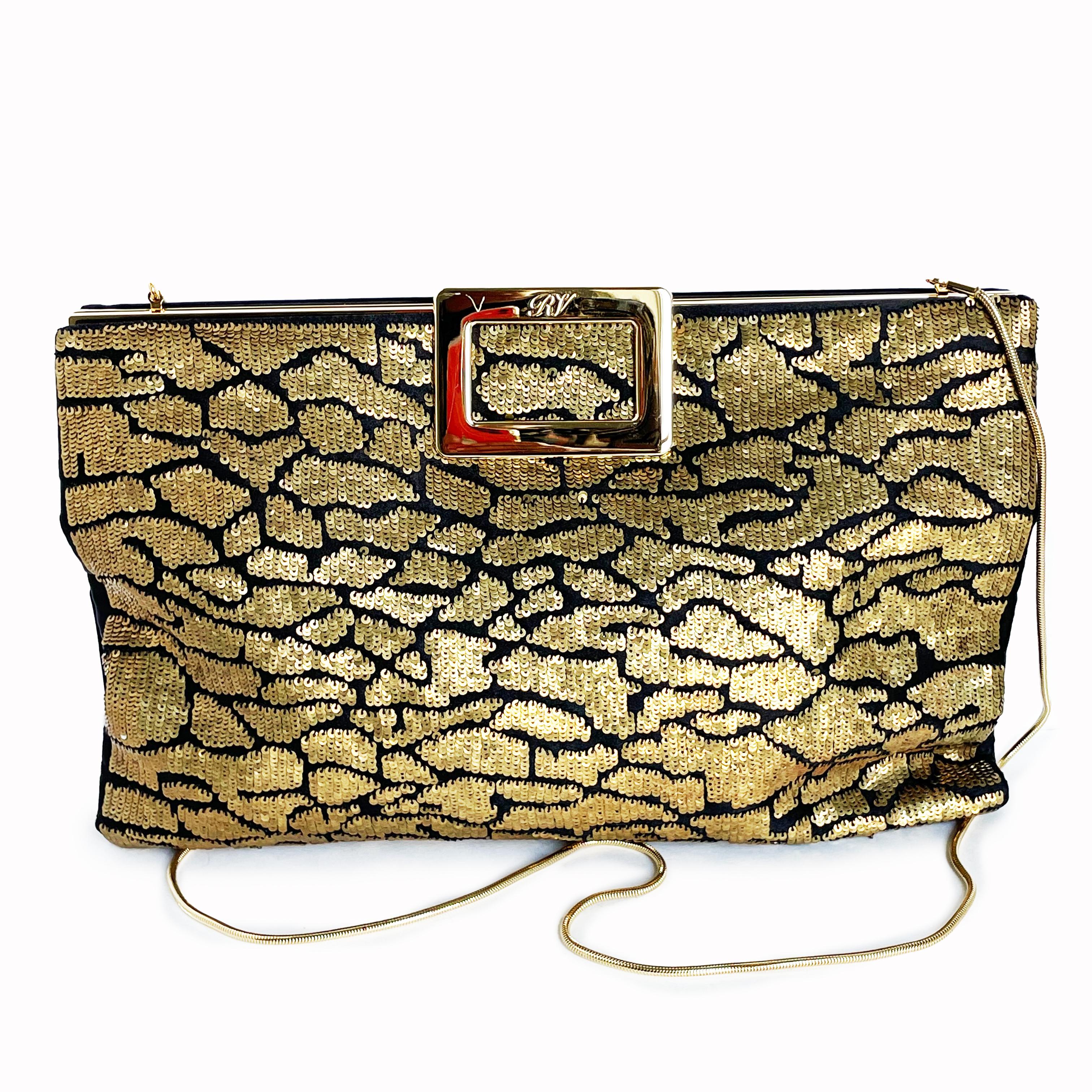This stylish evening bag was made by Roger Vivier Paris for the 2014 collection. Made from black silk satin and covered in an abstract pattern of tiny gold sequins in the front, this clutch bag features an oversized gold hinged closure bar and a